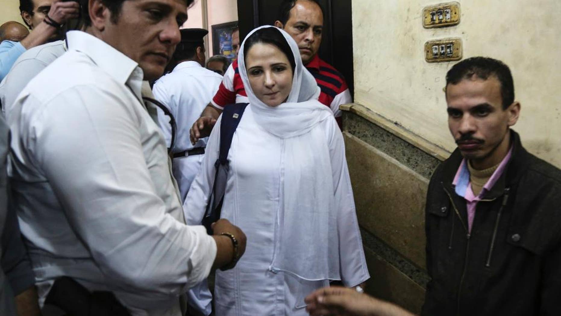 FILE -- In this Sunday, April 16, 2017 file photo, Aya Hijazi, center, a dual U.S.-Egyptian citizen, is acquitted by an Egyptian court after nearly three years of detention over accusations related to running a foundation dedicated to helping street children, in Cairo, Egypt. Hijazi's lawyer, Taher Abol Nasr, said she was released from prison late Tuesday, April 18, 2017, two days after a court acquitted her of charges of child abuse that were widely dismissed as bogus by human rights groups and U.S. officials. (AP Photo/Mohamed el Raai, File)