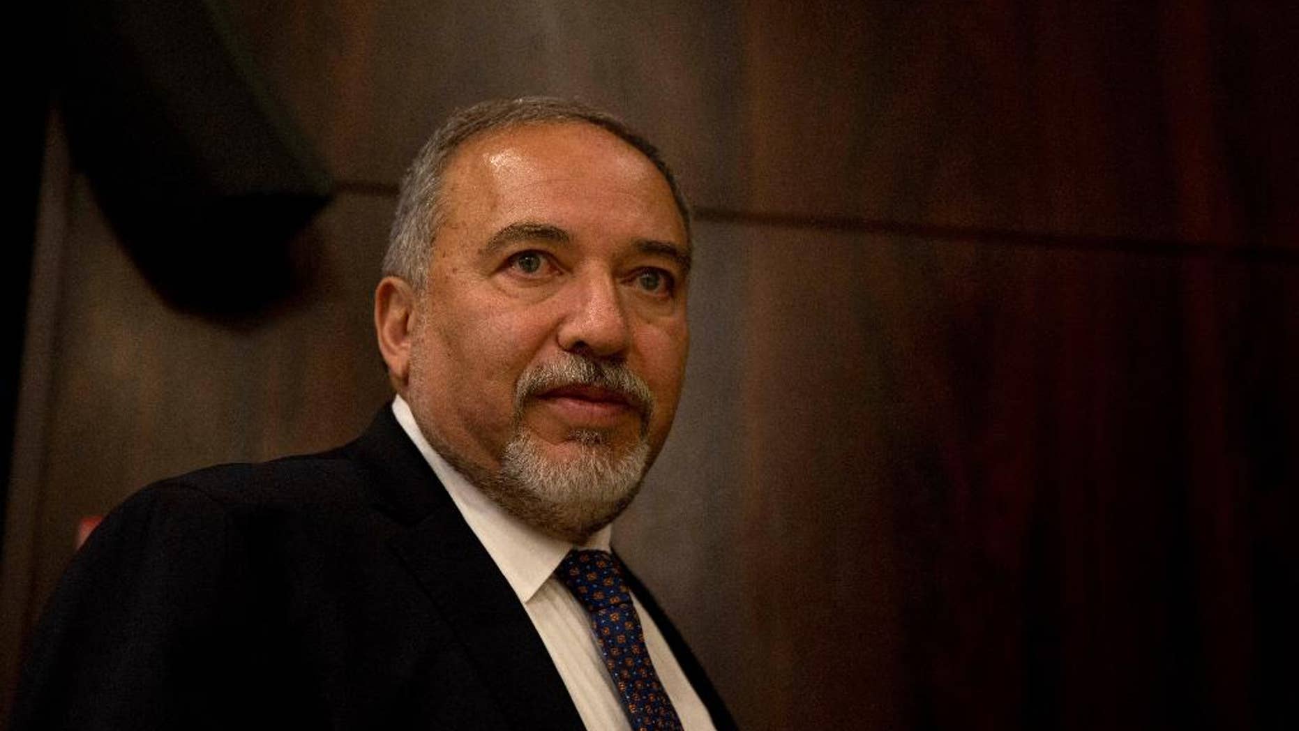 FILE -- In this May 30, 2016 file photo, Israeli Defense Minister Avigdor Lieberman appears at the Knesset, Israel's parliament, before his swearing-in ceremony, in Jerusalem. The Palestinian newspaper Al Quds, published a rare interview with Lieberman, where he reiterated his long held positions on Monday, Oct. 24, 2016. But for a Palestinian paper to interview an Israeli official is unusual and it comes at a time of heightened tensions and mistrust between the sides. Lieberman warned Gaza’s Hamas rulers and dismissed Palestinian President Mahmoud Abbas. Palestinians were angered by the interview. (AP Photo/Ariel Schalit, File)