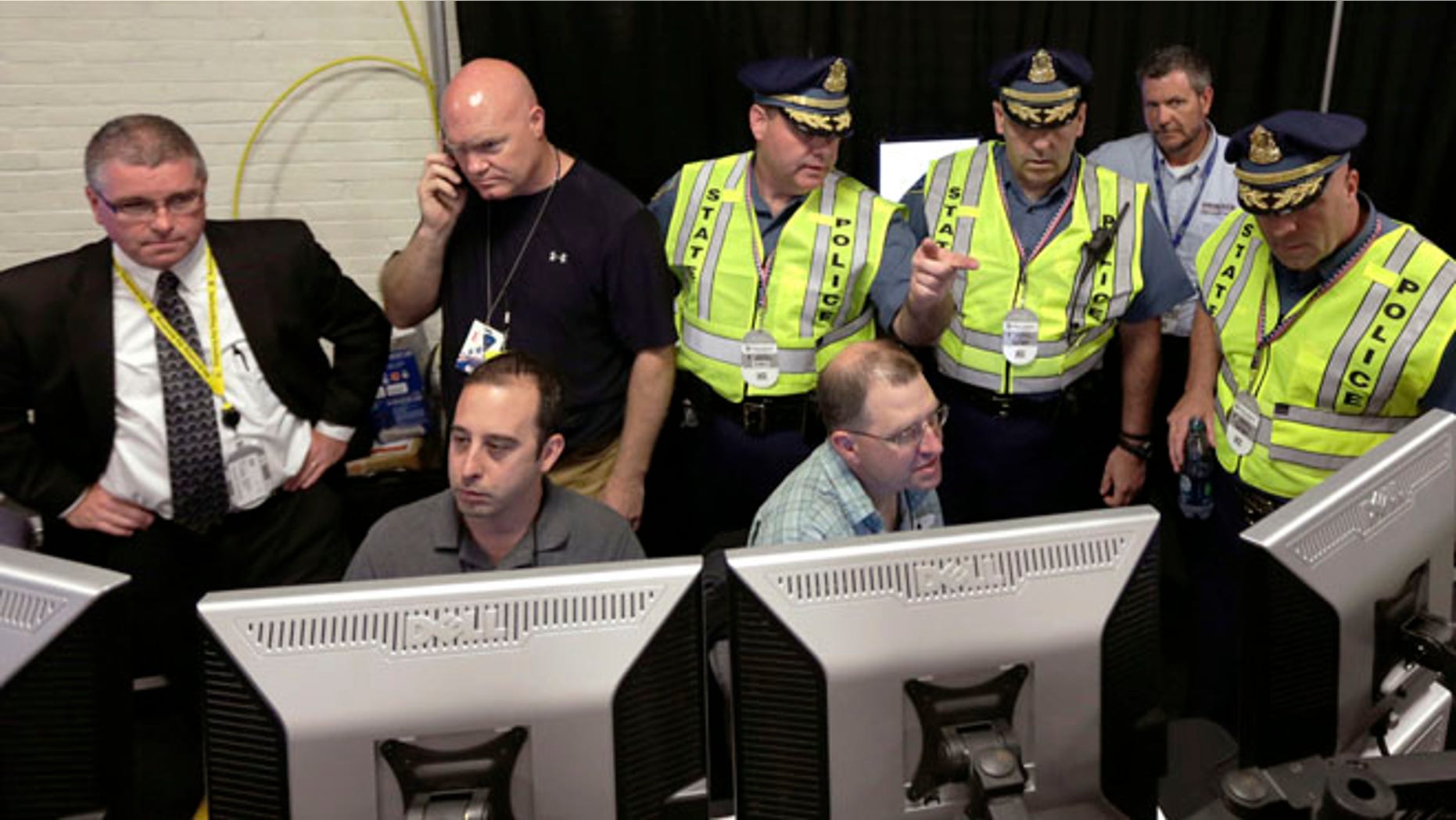 July 3, 2013: Law enforcement officials monitor surveillance cameras as part of an increased security effort for the Independence Day celebration, the first major public gathering since the Boston Marathon bombings, at the Unified Command Center in Boston.