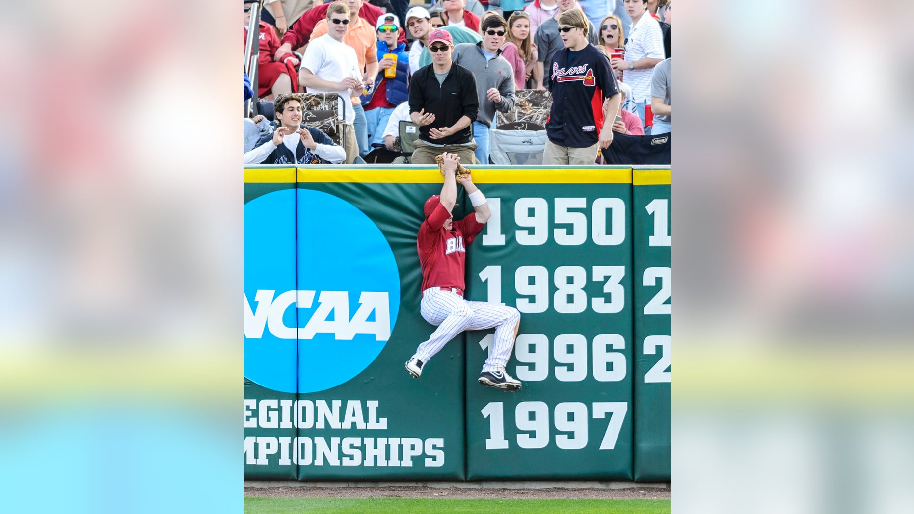 Alabama's Ben Moore makes a leaping play to save a home run and end the game during an NCAA college baseball game against Stephen F. Austin, Saturday, Feb. 22, 2014, in Tuscaloosa, Ala. (AP Photo/AL.com, Vasha Hunt)