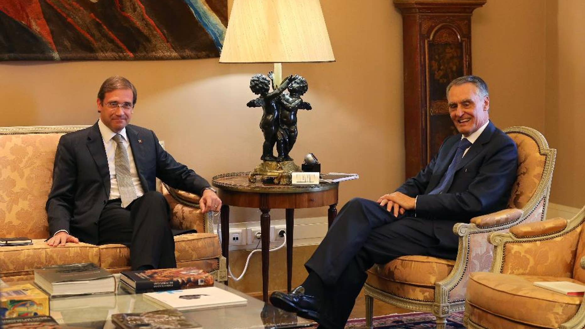 Portuguese Prime Minister Pedro Passos Coelho, left, is received by President Anibal Cavaco Silva at the Belem presidential palace in Lisbon, Portugal, Tuesday, Oct. 6, 2015. Cavaco Silva has began a round of meetings to decide on the best path forward following Sunday's general elections. The incumbent center-right government collected most votes but lost its outright majority in Parliament. (AP Photo/Armando Franca)