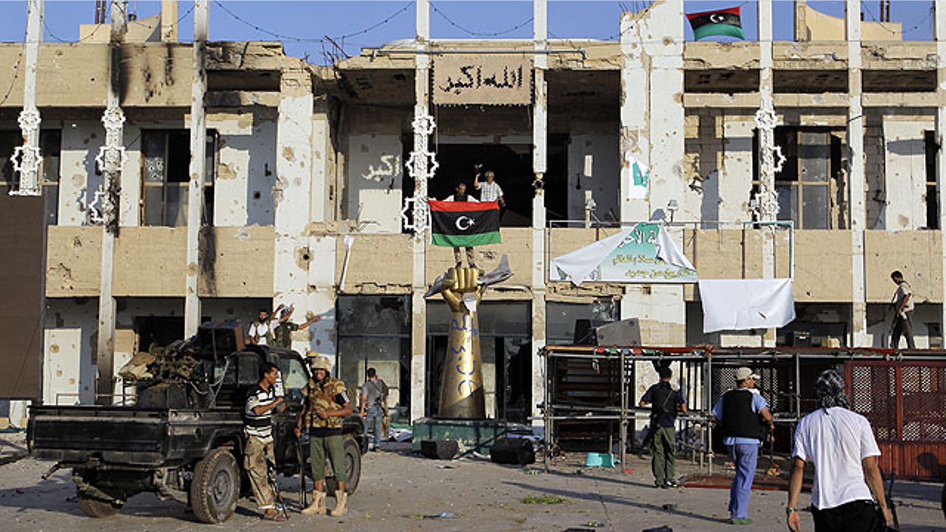 August 23: Rebel fighters seen inside the main Muammar Qaddafi compound in Bab al-Aziziya in Tripoli, Libya.