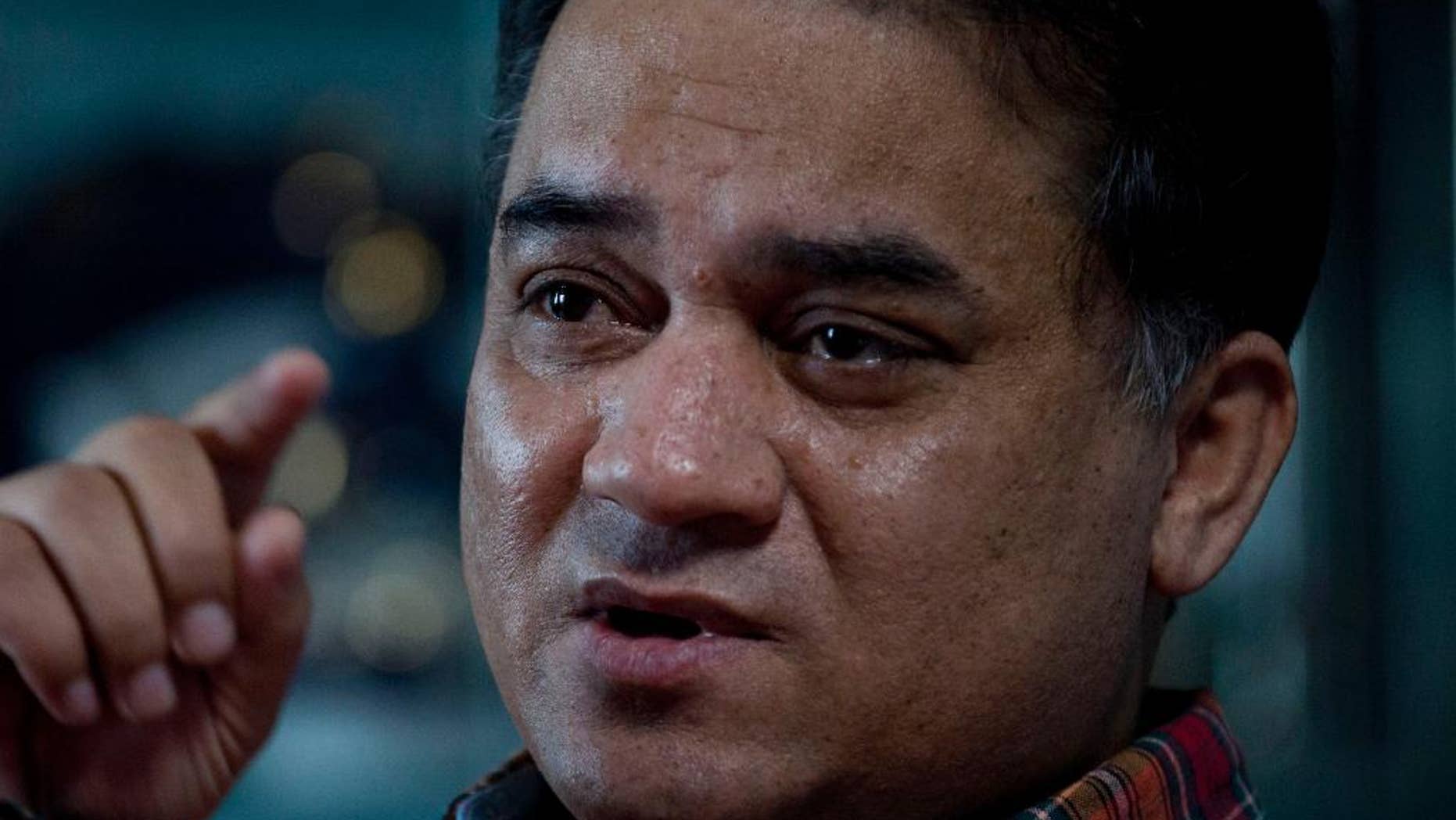 Guzulnur, wife of Ilham Tohti arrives at Urumqi People's Intermediate Court to attend her husband's trial in Urumqi, China's northwestern region of Xinjiang Thursday, Sept. 18, 2014. The defense in the separatism trial of Tohti, a Muslim Uighur scholar, sought to show Thursday that his classroom lectures and online commentary never amounted to a campaign to split his native region of Xinjiang away from China. (AP Photo/Jack Chang)