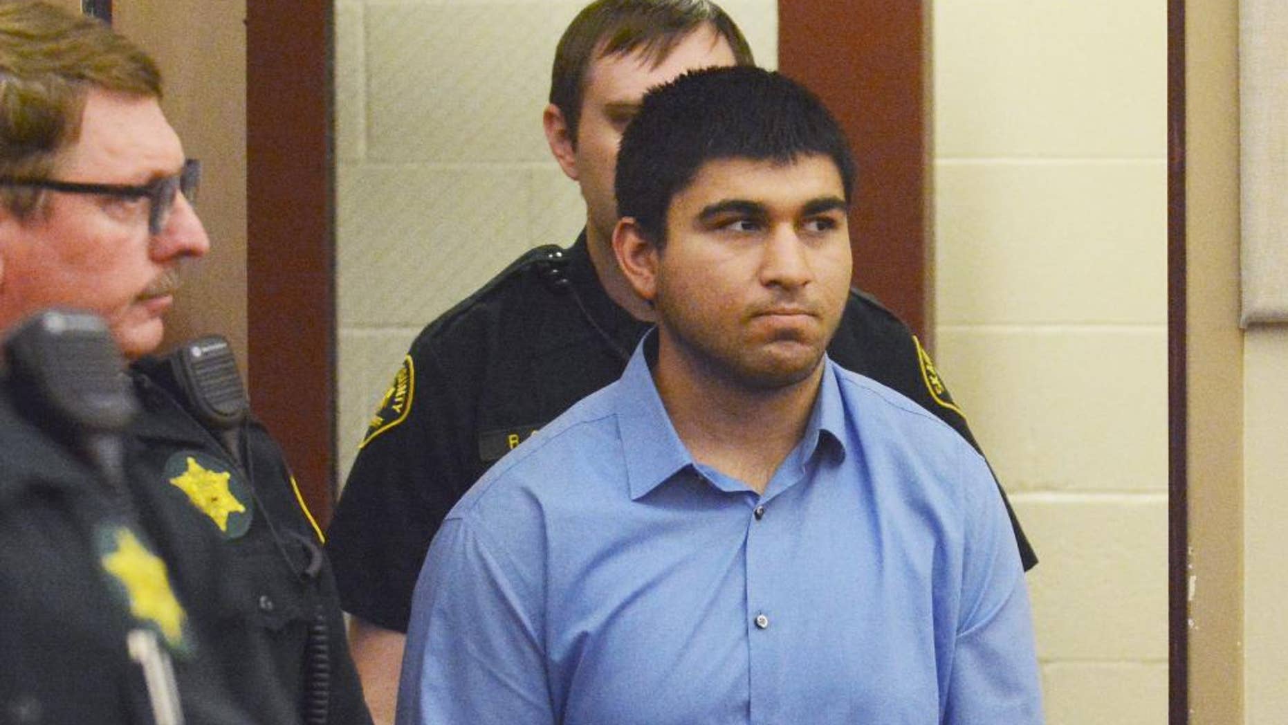 Arcan Cetin is escorted into Skagit County District Court by Skagit County's Sheriff's Deputies on Monday, Sept. 26, 2016. Cetin is being held under a magistrate's warrant which will give Skagit County prosecutors 30 days to file charges in relation to the Cascade Mall shooting that took place on Friday evening. Five people were killed in the shooting, and Cetin is being held on a $2 million bail. (Brandy Shreve/Skagit Valley Herald via AP)