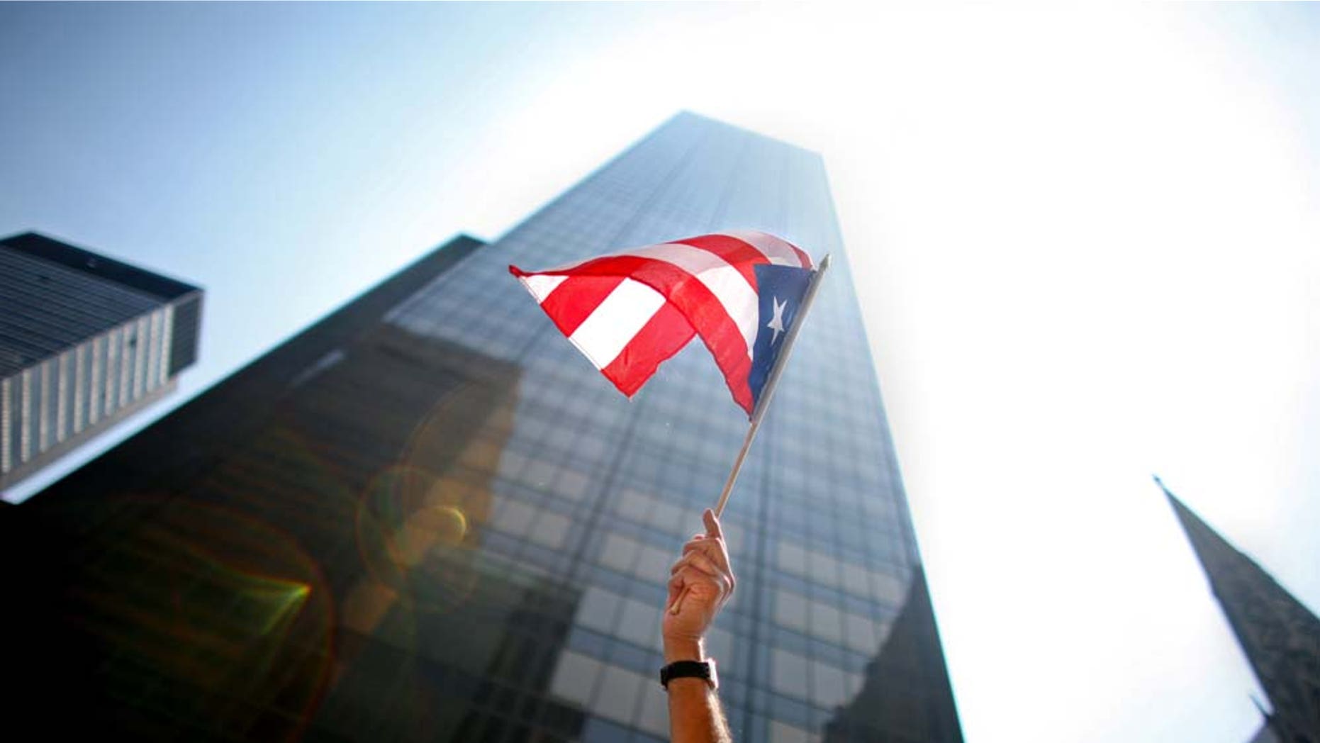 NEW YORK CITY - JUNE 8: A participant waves a flag in the annual Puerto Rico Day Parade June 8, 2008 in New York City. The parade honoring Puerto Ricans is an annual New York City tradition and takes place along Fifth Avenue. (Photo by Yana Paskova/Getty Images)