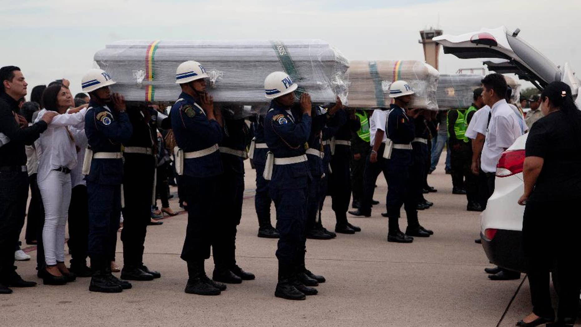 Coffins carrying LaMia flight crew members who died in a plane crash are carried by soldiers to a hearse at the Viru Viru airport in Santa Cruz, Bolivia, Friday, Dec. 2, 2016. Victims of this week's tragic air crash in the Andes were flown home Friday as Bolivia's president called for "drastic measures" against aviation officials who signed off on a flight plan that experts and even one of the charter airline's executives said should never have been attempted because of a possible fuel shortage. (AP Photo/Juan Karita)