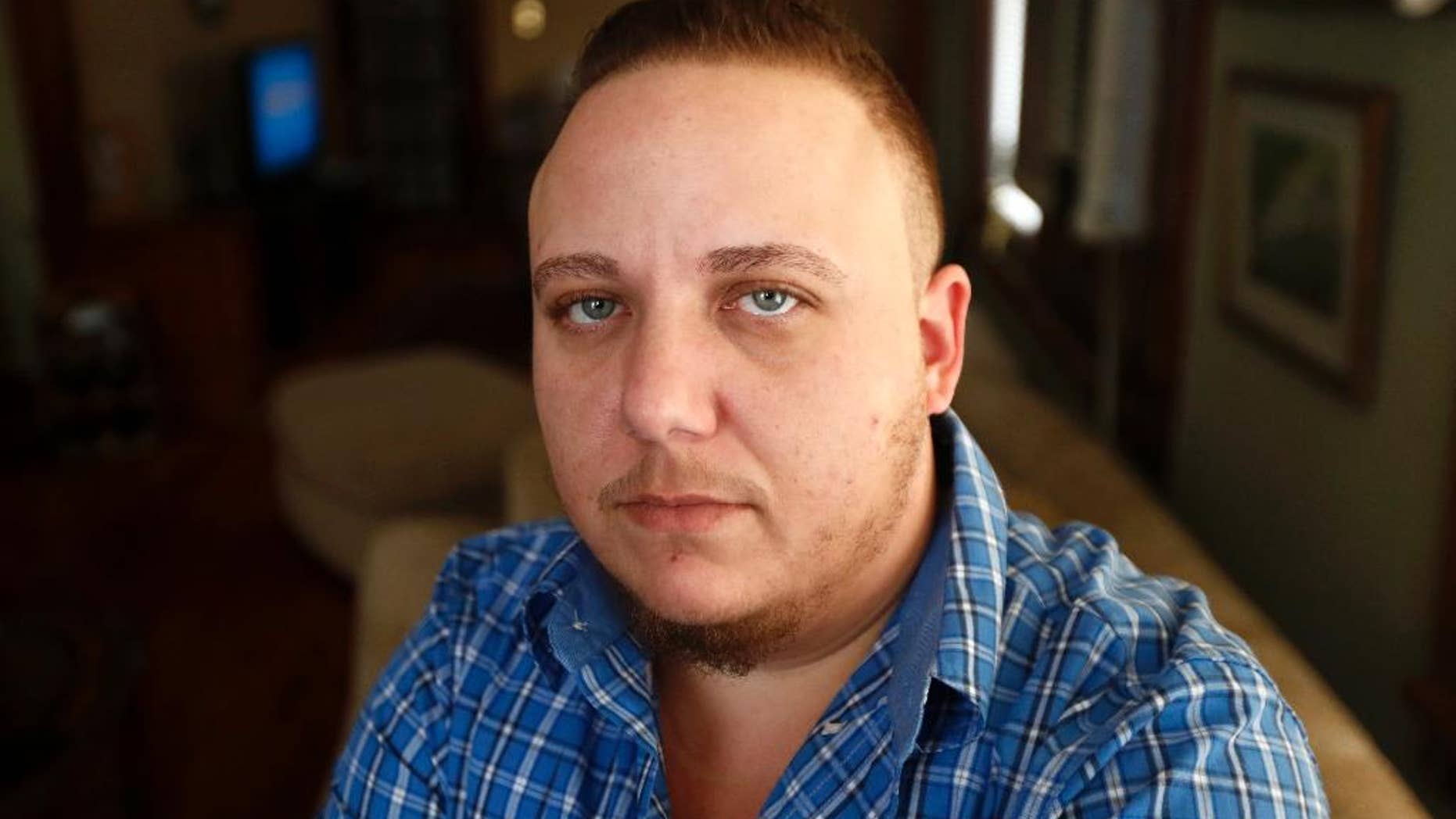 FILE – In this Jan. 5, 2017, file photo, Jionni Conforti, a transgender man who filed a federal lawsuit after uterus removal surgery as part of his sex transition was canceled by St. Joseph's Regional Medical Center in Paterson, N.J., poses for a portrait by The Associated Press in his home in Totowa, N.J. Saint Joseph's Healthcare System denies unfairly discriminating against Conforti, arguing in the Catholic hospital's Friday, Feb. 10, 2017, response to the lawsuit that a court ruling in the transgender man's favor would violate freedom of religion. (AP Photo/Julio Cortez, File)