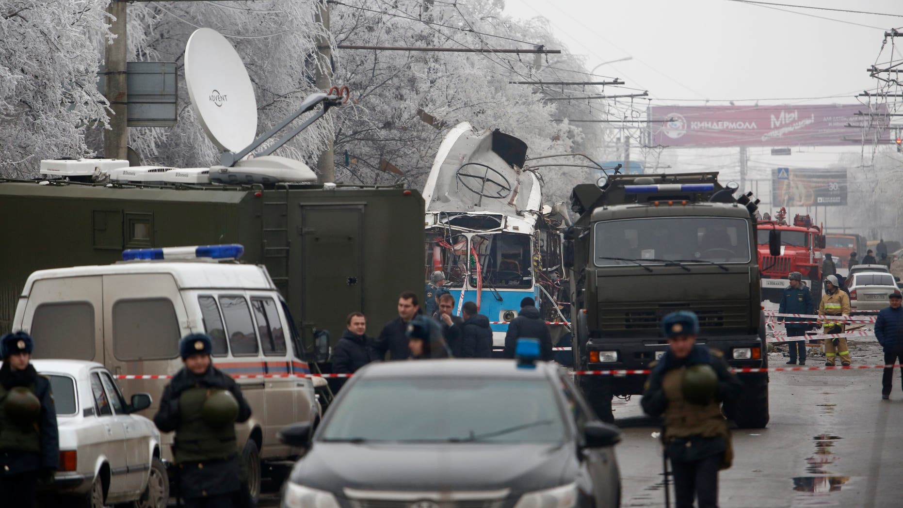 Military vehicles surround a wreckage of a trolleybus, in Volgograd, Russia, Monday, Dec. 30, 2013. A bomb blast tore through a trolleybus in the city of Volgograd on Monday morning, killing at least 10 people a day after a suicide bombing that killed at least 17 at the city's main railway station. Volgograd is about 650 kilometers (400 miles) northeast of Sochi, where the Olympics are to be held. (AP Photo/Denis Tyrin)