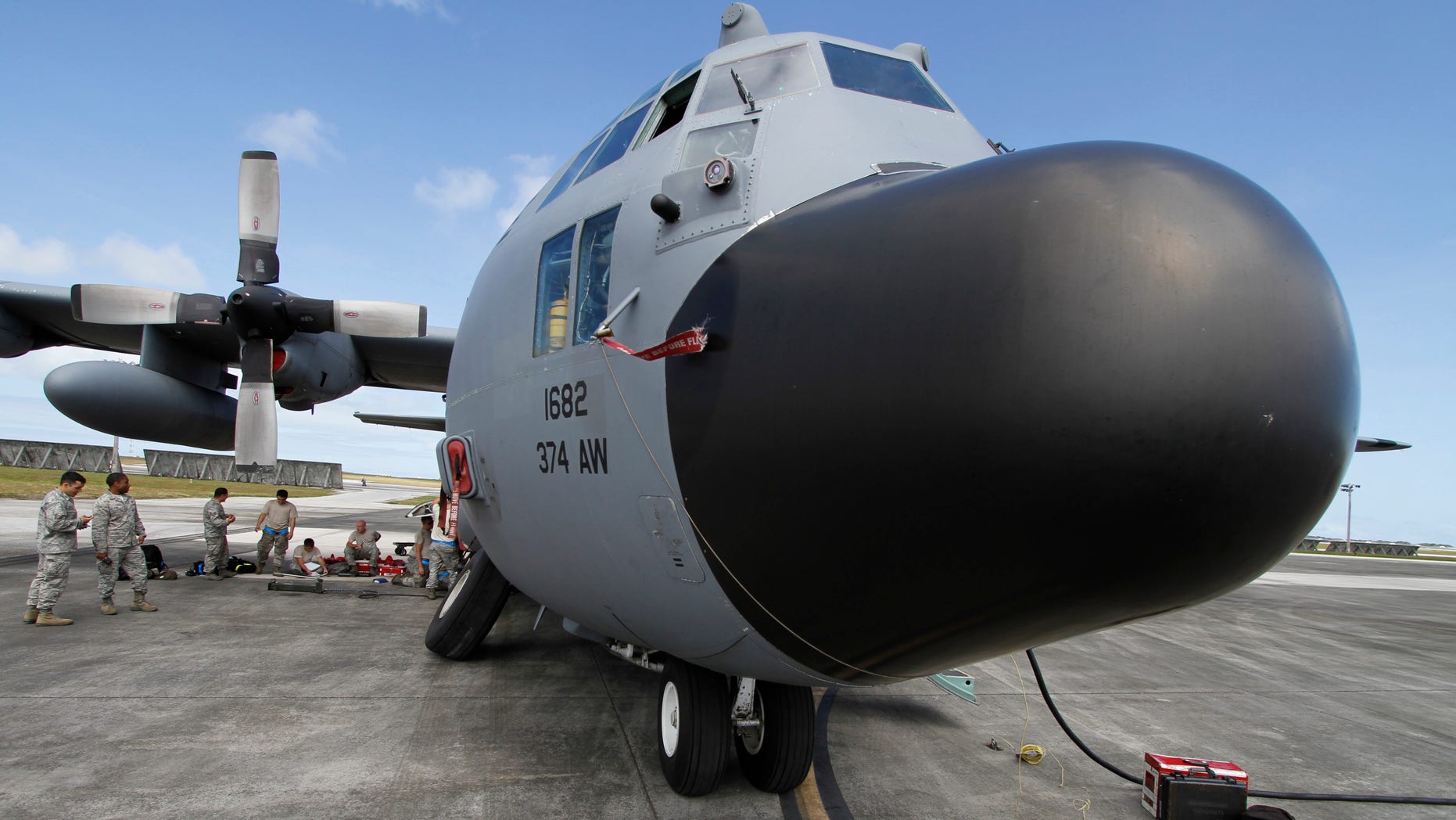 Feb. 7, 2013: Members of the 374th Airlift Wing of U.S. Air Force work on a C-130 aircraft during the Cope North military exercises at Andersen U.S. Air Force Base in Guam.