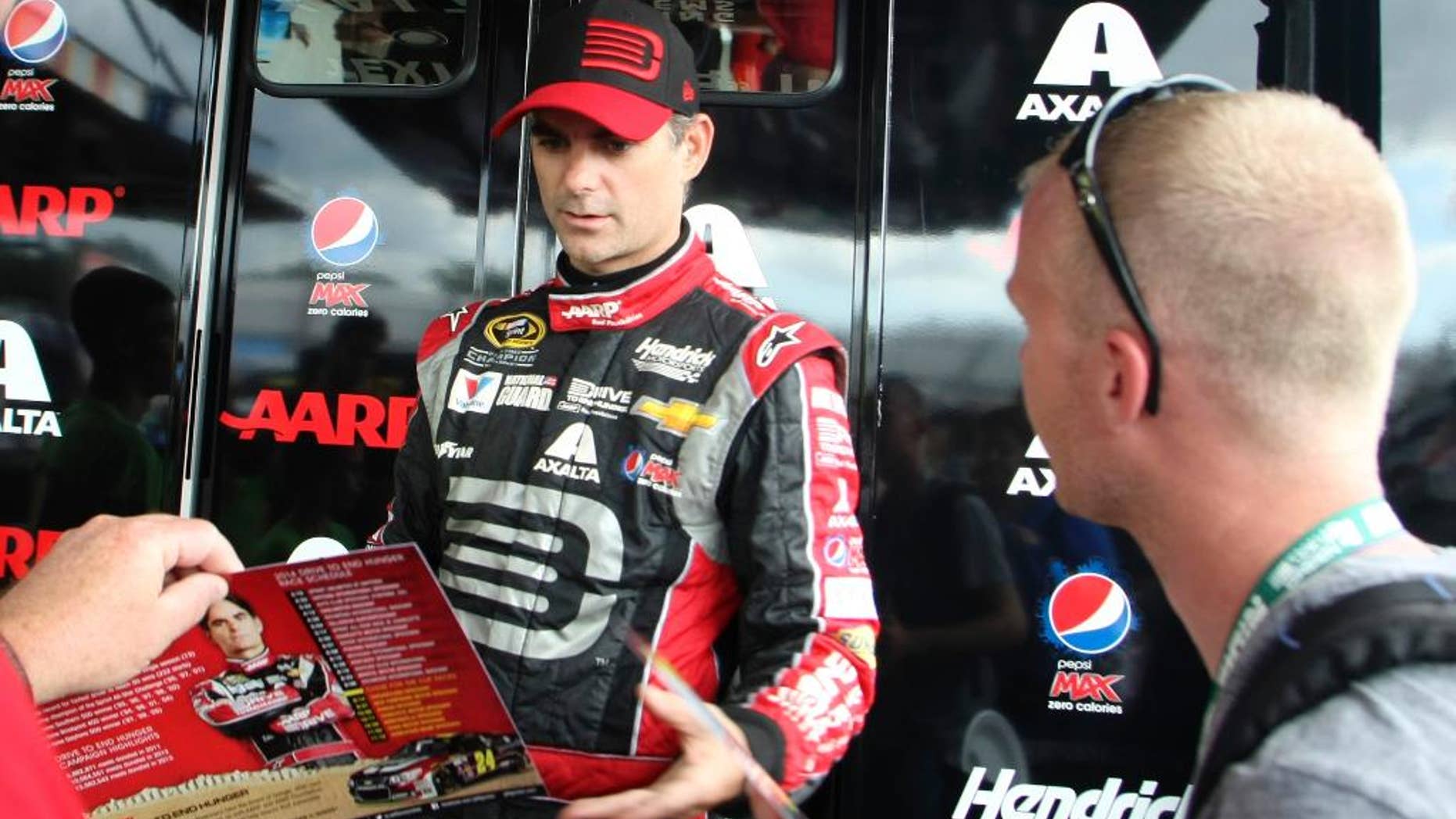 Driver Jeff Gordon signs autographs during a break in practice for Saturday night's NASCAR Sprint Cup series auto race at Richmond International Raceway, Friday Sept. 5, 2014, Richmond, Va. (AP Photo/Jason Hirschfeld)