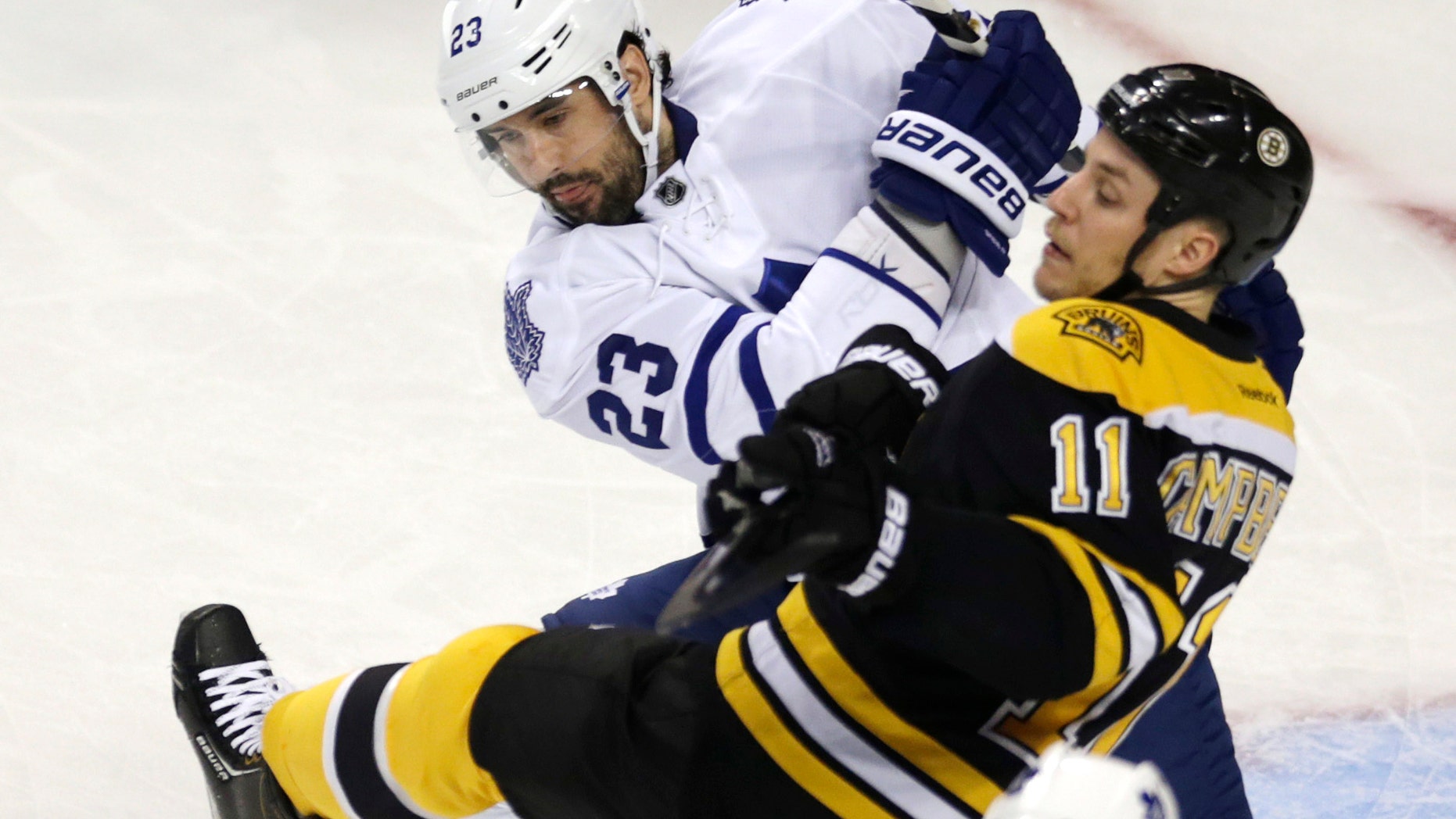 Toronto Maple Leafs defenseman Ryan O'Byrne (23) checks Boston Bruins center Gregory Campbell (11) during the first period in Game 5 of an NHL hockey Stanley Cup playoff series in Boston, Friday, May 10, 2013. (AP Photo/Charles Krupa)
