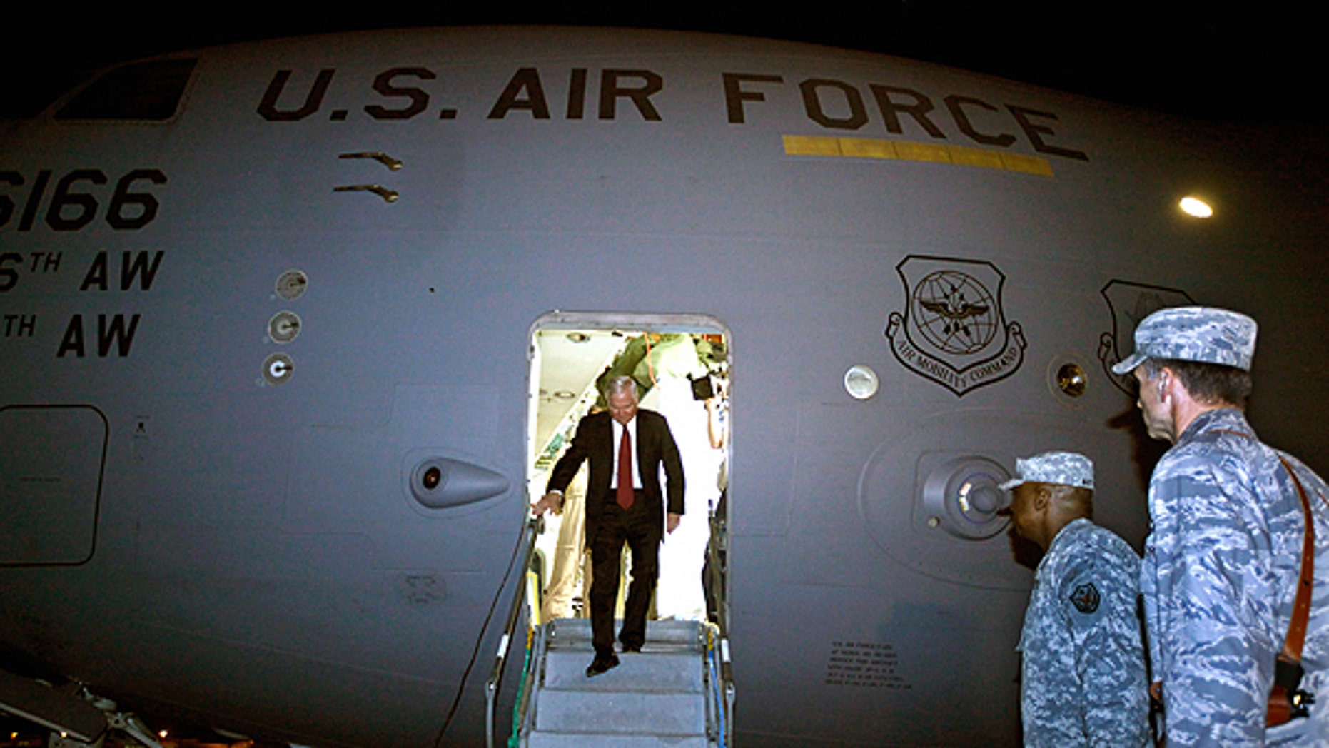 April 6: U.S. Defense Secretary Robert Gates steps off of his C-17 airplane before being met by U.S. Army Gen. Lloyd Austin, center, commanding general of U.S. Forces in Iraq, in Baghdad, Iraq.