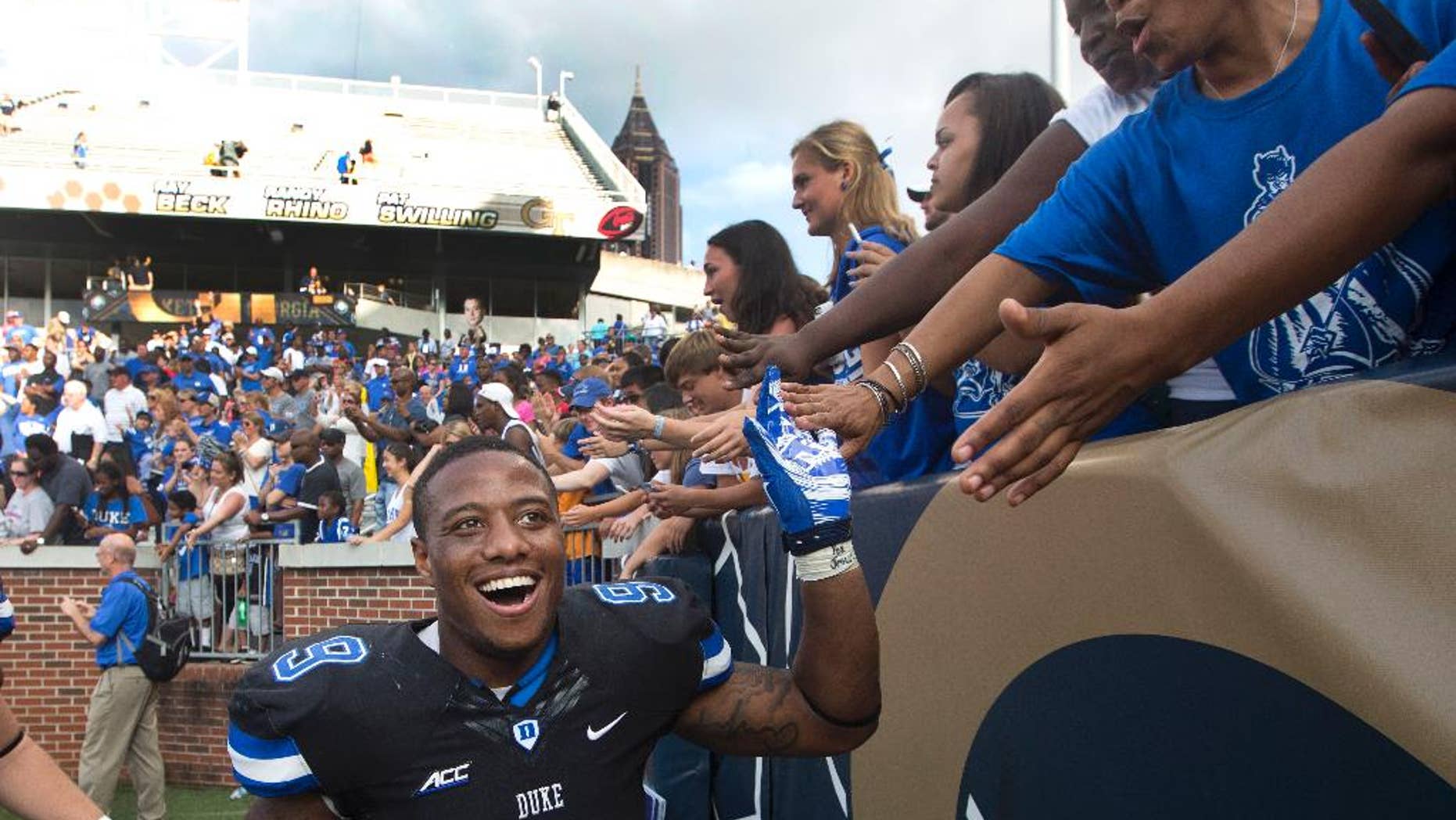 Duke running back Josh Snead (9) celebrates with fans after defeating Georgia Tech 31-25 in an NCAA college football game Saturday, Oct. 11, 2014, in Atlanta. (AP Photo/John Bazemore)