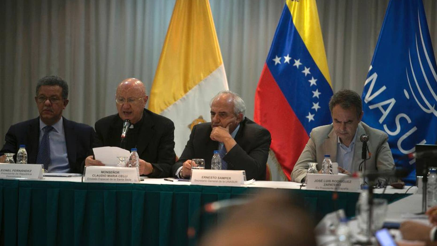 International mediators, from left to right, Dominican Republic's former President Leonel Fernandez, Vatican envoy Archbishop Claudio Maria Celli, Colombian former President Ernesto Samper, and Spain's former Prime Minister Jose Luis Rodriguez Zapatero, sit at the dialogue table between Venezuela's government and its opposition, in Caracas, Venezuela, Friday, Nov, 11 , 2016. The government and the opposition meet on Friday with international mediators to assess the progress of talks aimed at defusing the political crisis in Venezuela following the suspension of the referendum revoking Venezuelan President Nicolas Maduro's term. (AP Photo/Alejandro Cegarra)