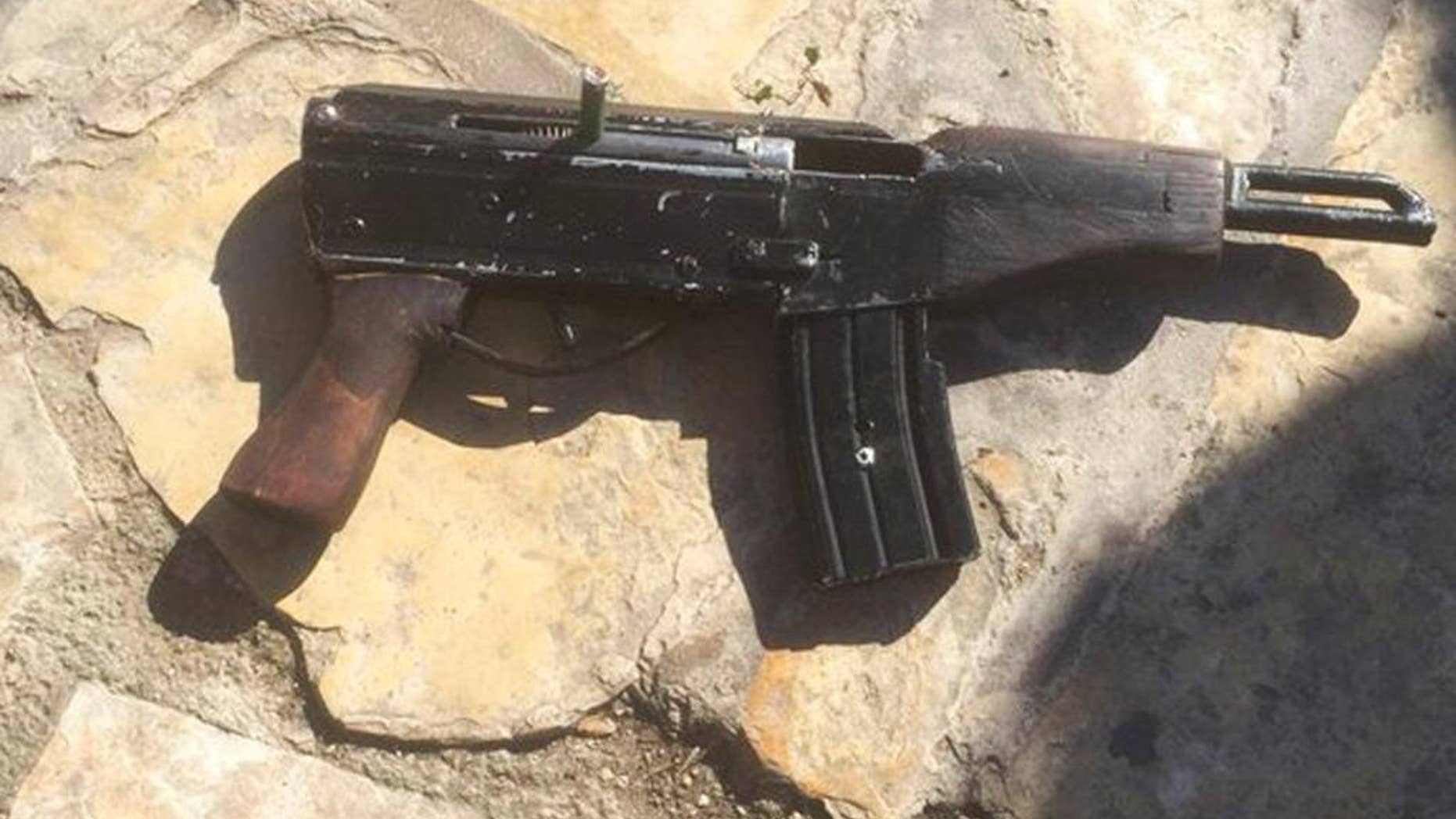 This undated photo provided by the Israeli Police shows a handmade gun produced in the West Bank. Welded together from spare gun parts and pipes, the gun looks like a handgun but with an extended barrel and a long magazine of bullets. The weapon, known by its street name "Carlo," was used by Palestinian gunmen to kill four people and wound five others in Tel Aviv on Wednesday night as well as several other attacks since the current round of violence erupted in September. (Israeli Police via AP)