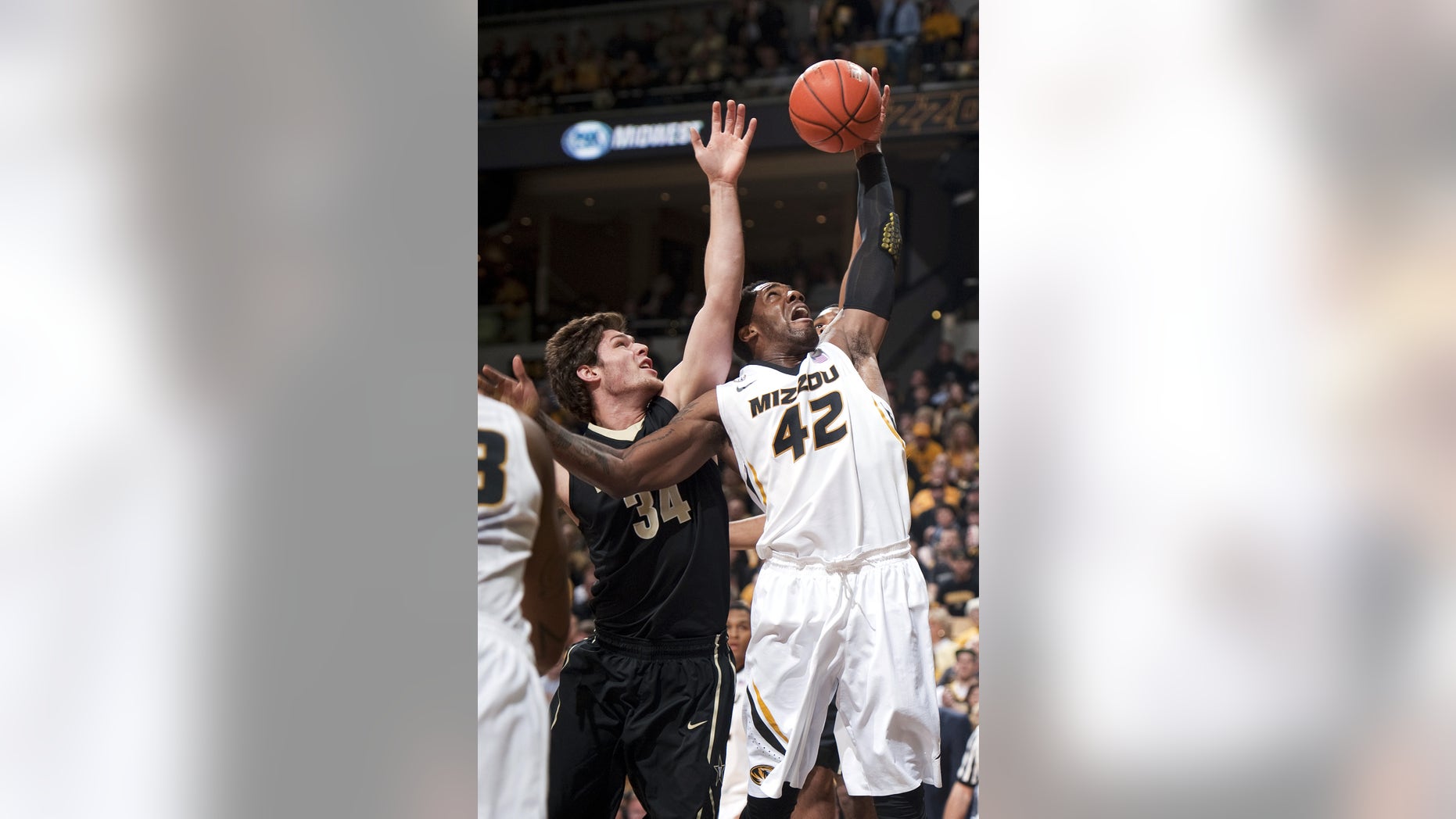 Missouri's Alex Oriakhi, right, pulls down a rebound in front of Vanderbilt's Shelby Moats, left, during the first half of an NCAA college basketball game Saturday, Jan. 26, 2013, in Columbia, Mo. (AP Photo/L.G. Patterson)