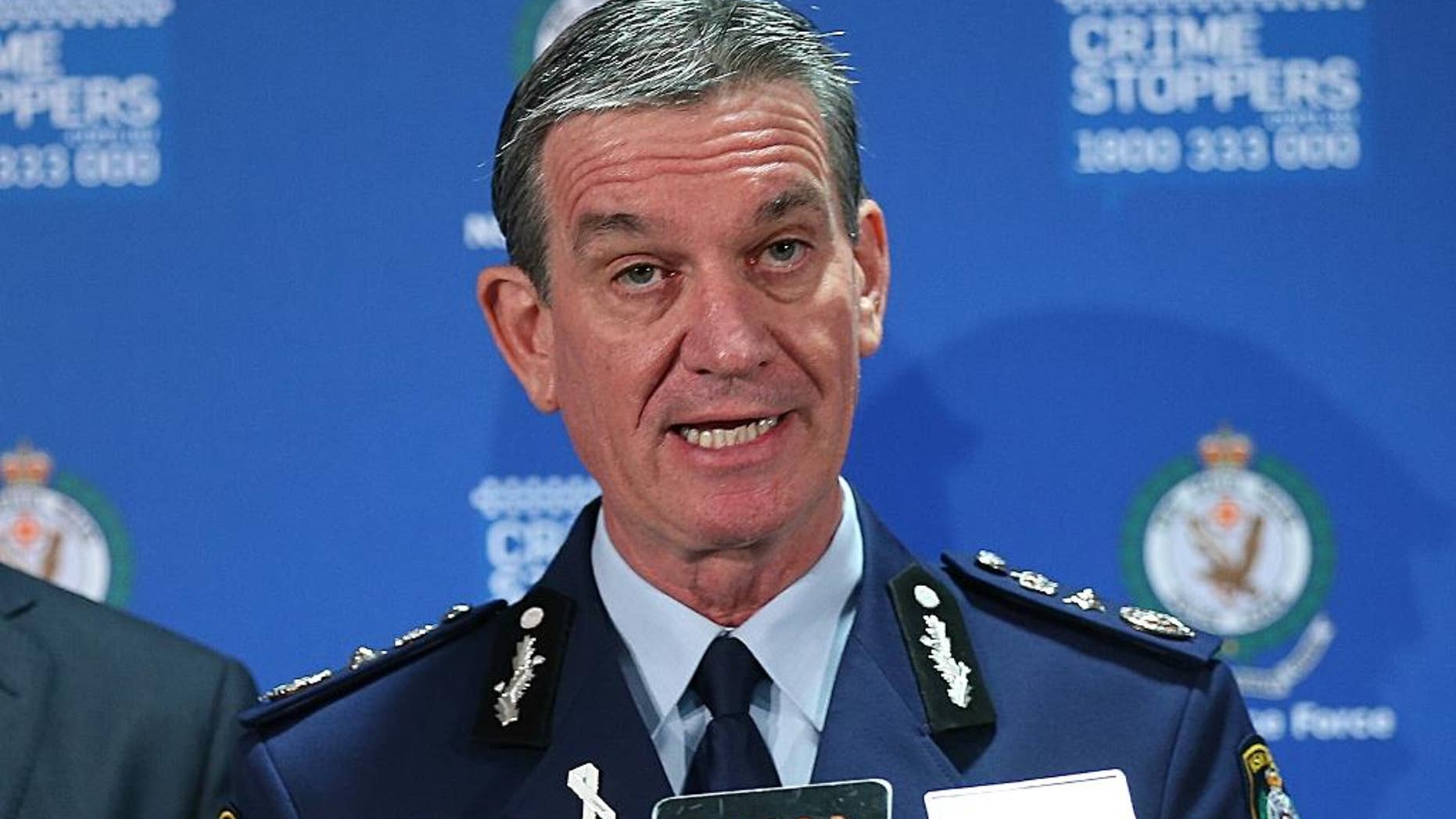FILE - In this Dec. 16, 2014, file photo, police commissioner Andrew Scipione speaks during a press conference in the central business district of Sydney. An Iranian teenager fatally shot a civilian member of Sydney's police force in a killing that authorities believe is linked to terrorism, officials said Saturday, Oct. 3, 2015. The 15-year-old, who is of Iraqi-Kurdish background and was born in Iran, shot a New South Wales police finance worker with a handgun at close range as the man left work in the western Sydney suburb of Parramatta on Friday, Oct. 2, 2015, Scipione said. The teen then fired at responding officers, who shot and killed him, Scipione said. (AP Photo/Rob Griffith, File)