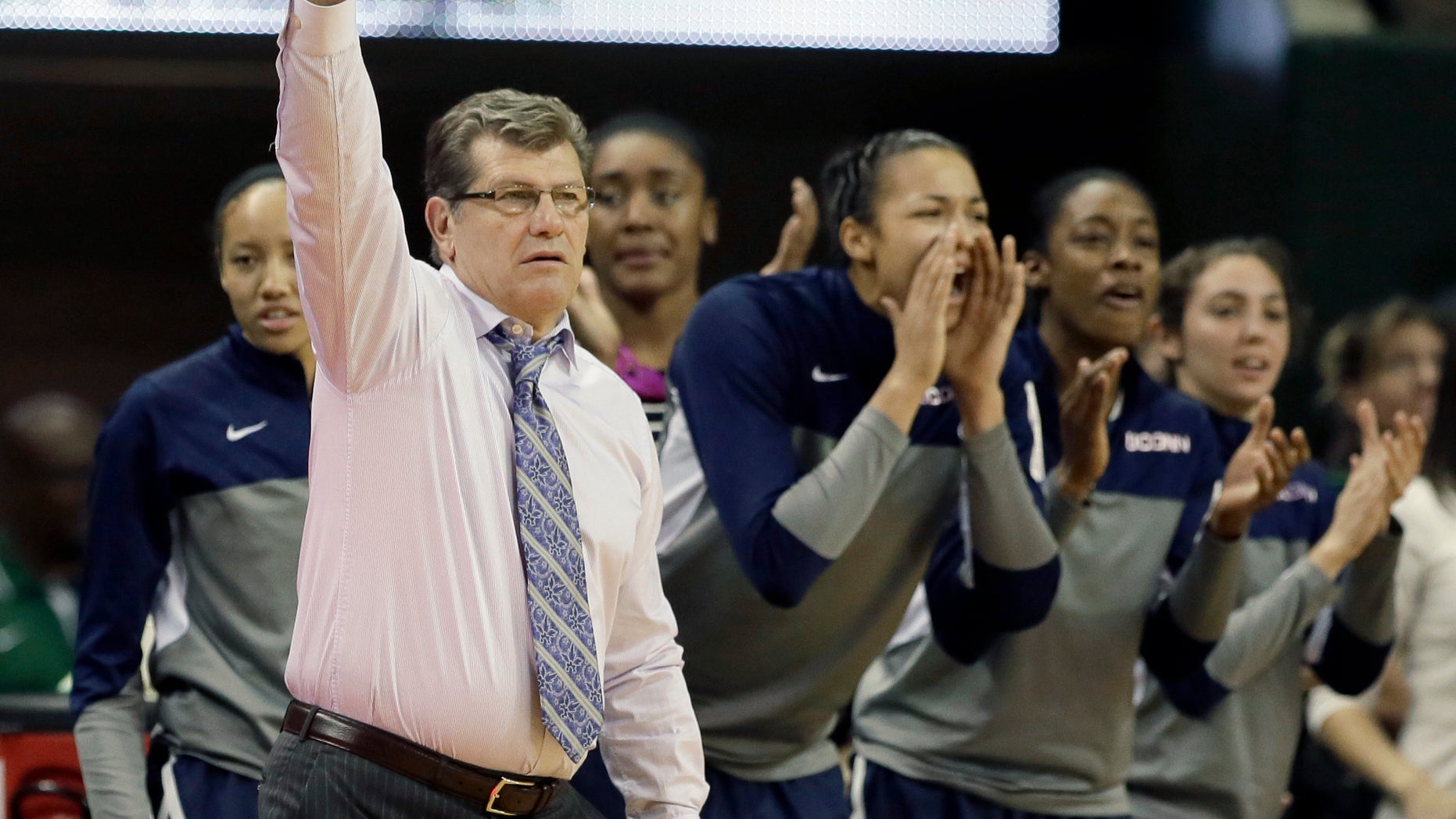 Connecticut head coach Geno Auriemma instructs the defense as the bench cheers late in the second half of an NCAA college basketball game against Baylor, Monday, Jan. 13, 2014, in Waco, Texas. Connecticut won 66-55. (AP Photo/Tony Gutierrez)