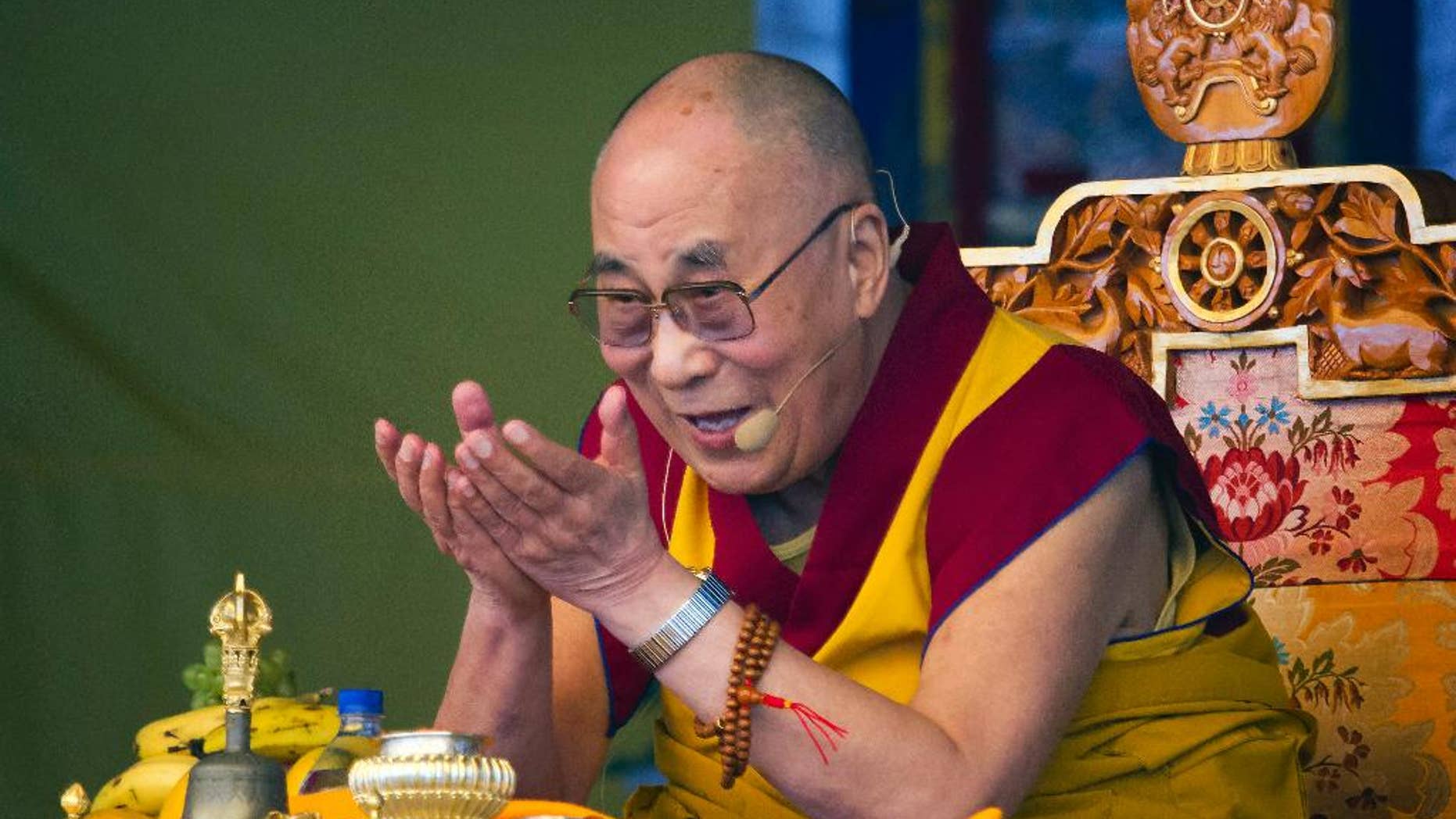 FILE - In a Friday, May 29, 2015 file photo, Tibetan spiritual leader the Dalai Lama gestures as he talks during a special ritual ceremony at the Tibetan Children's Village School in Dharmsala, India. The National Constitution Center CEO Jeffrey Rosen announced Wednesday, June 17, 2015 that the Dalai Lama will be honored with Philadelphia’s Liberty Medal for his efforts to promote compassion and human rights around the globe. (AP Photo/Ashwini Bhatia, File)