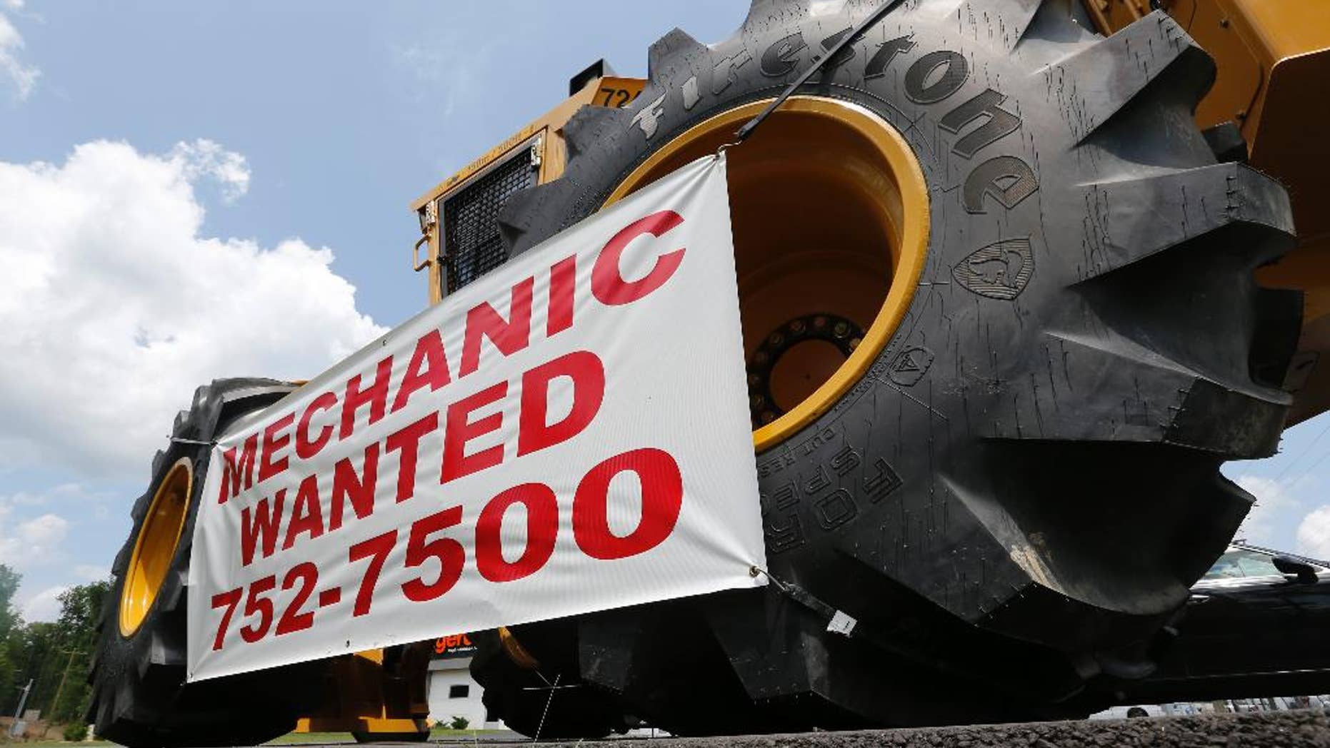 A help wanted sign is posted at a tractor dealership in Ashland, Va., Tuesday, June 9, 2015. The U.S. Labor Department reports on the number of people who applied for unemployment benefits during the week ending June 6 on Thursday, June 11, 2015. (AP Photo/Steve Helber)
