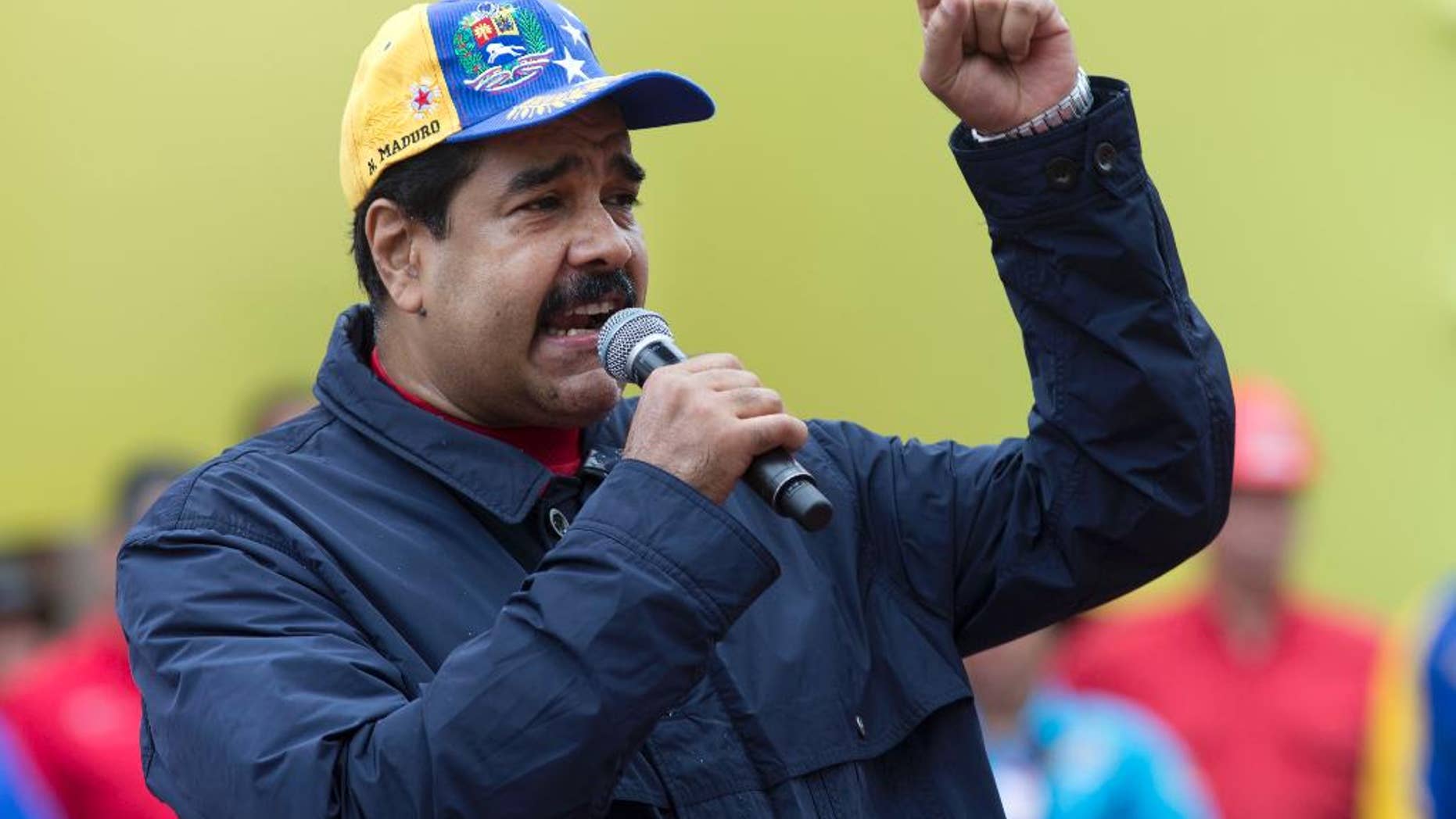 Venezuela's President Nicolas Maduro speaks during a May Day march in Caracas, Venezuela, Sunday, May 1, 2016. President Maduro ordered a 30 percent increase in the minimum wage, the latest move by the socialist government to grapple with high inflation and economic stagnation. (AP Photo/Ariana Cubillos)