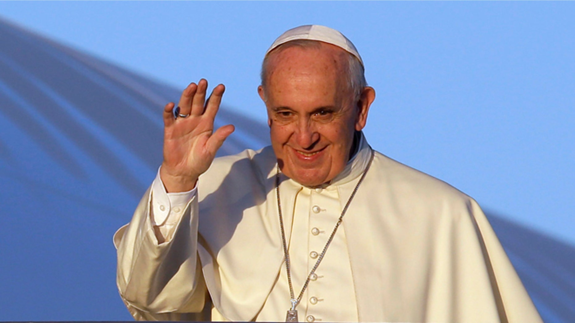 Pope Francis waves to journalists as he boards his airplane to Africa on Nov. 25, 2015.
