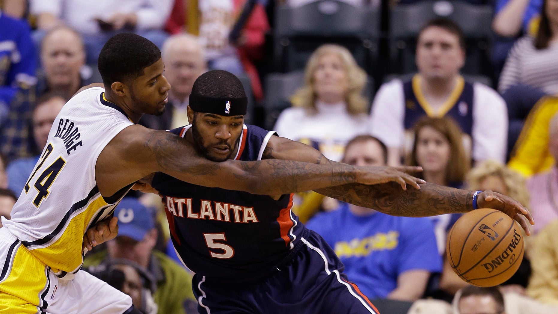 Atlanta Hawks' Josh Smith (5) is defended by Indiana Pacers' Paul George during the second half of Game 1 in the first round of the NBA basketball playoffs Sunday, April 21, 2013, in Indianapolis. Indiana defeated Atlanta 107-90. (AP Photo/Darron Cummings)