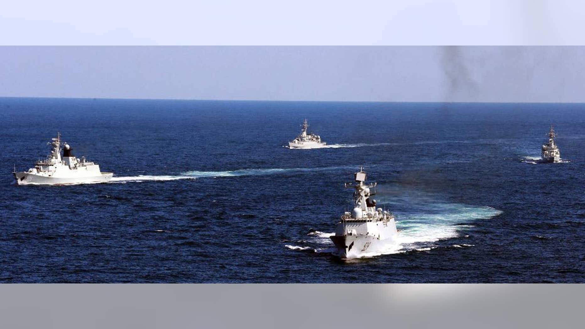 FILE - In this Oct. 19, 2012 file photo, Chinese navy vessels take part in a drill in the waters off Zhoushan in east China's Zhejiang province. Despite pressure from Washington and elsewhere, China appears determined to avoid granting any hint of legitimacy to the U.N. abitration tribunal that might challenge its claim to ownership of virtually the entire South China Sea, including its islands, reefs, fish stocks and potentially rich reserves of oil and gas. (AP Photo/File) CHINA OUT