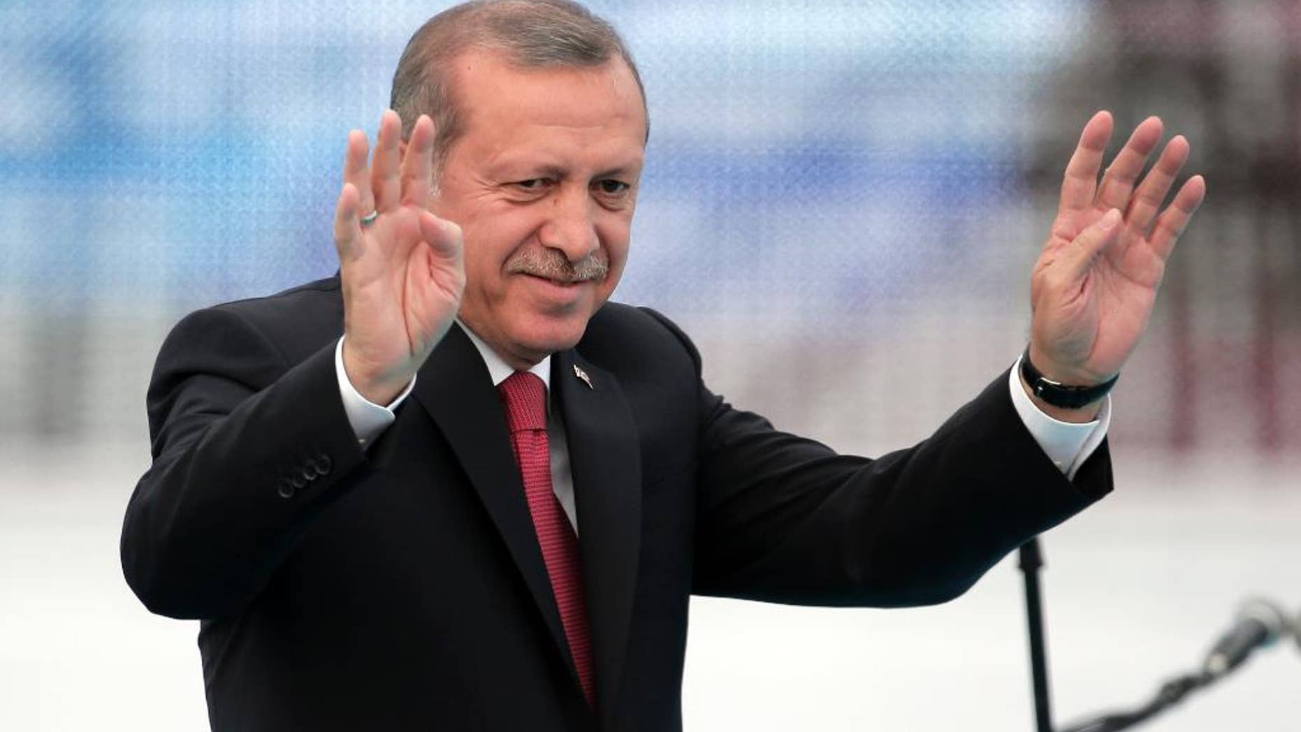 Turkey's President Recep Tayyip Erdogan waves to people gathered during a rally to commemorate the anniversary of the city's conquest by the Ottoman Turks, Istanbul, Turkey, Saturday, May 30, 2015. The Justice and Development Party (AKP), which has been ruling Turkey since 2002, is running in the upcoming general elections which are to be held on June 7, 2015, where approximately 56 million Turkish voters are eligible to cast their ballots to elect the 550 members of the Grand National Assembly. (AP Photo/Lefteris Pitarakis)