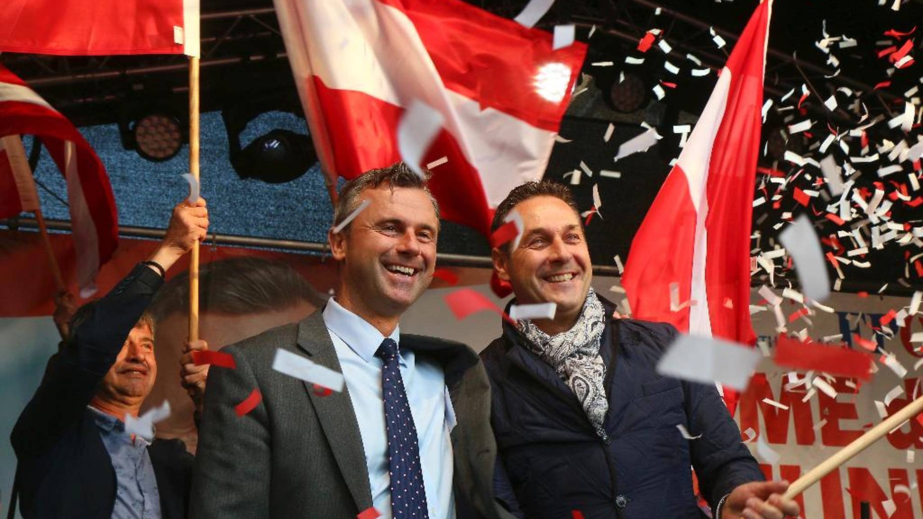 FILE - In this May 20, 2016 file photo Norbert Hofer candidate for presidential elections of Austria's Freedom Party, FPOE, and Heinz-Christian Strache, from left, head of Austria's Freedom Party, FPOE, look out at supporters during the final election campaign event in Vienna. An Austrian supreme court justice has rejected the powerful right-wing party's demand that he stop repeating a claim that the party views as harming its image. The Freedom Party wants Johannes Schnizer to stop saying that it prepared a legal challenge to results of presidential elections long before announcing it was doing so. His lawyer said Thursday, Oct. 5, 2016 Schnizer would not meet the demand. (AP Photo/Ronald Zak)