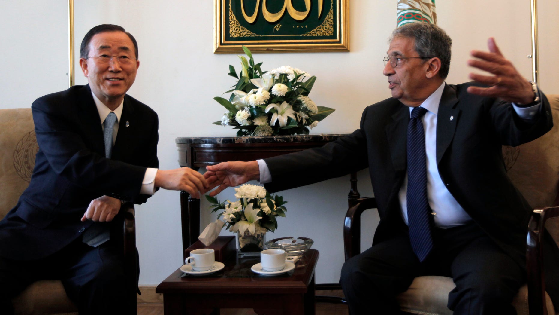 March 21: UN Secretary-General Ban Ki-moon, left, shakes hands with Arab League chief Amr Moussa during a meeting at the Arab League headquarters in Cairo, Egypt. A group of protesters angry about international intervention in Libya blocked the path of U.N. Secretary-General Ban Ki-Moon as he left a meeting at the Arab League.