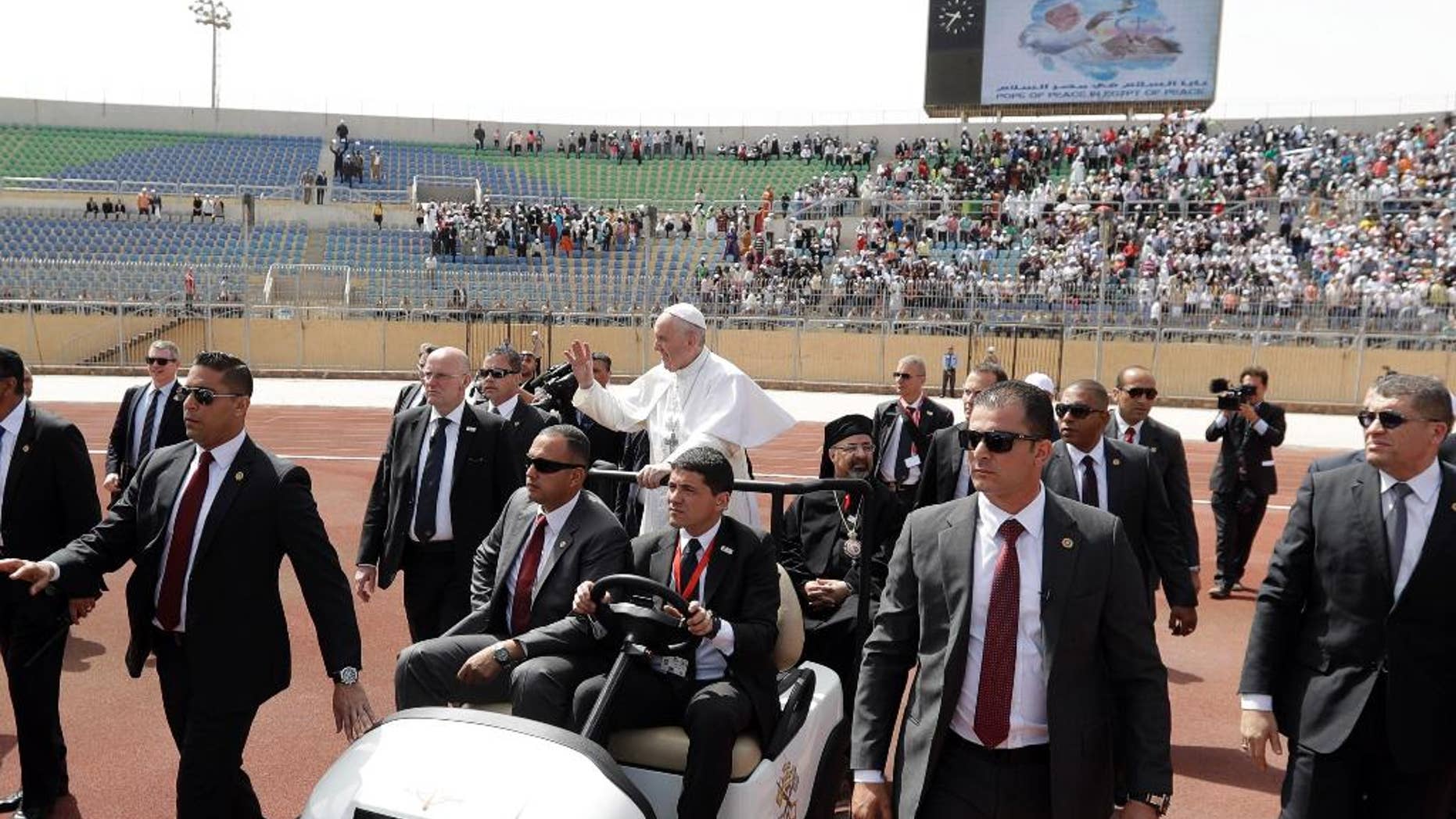 Pope Francis waves as he arrives to celebrate Mass for Egypt's tiny Catholic community, at the Air Defense Stadium in Cairo.
