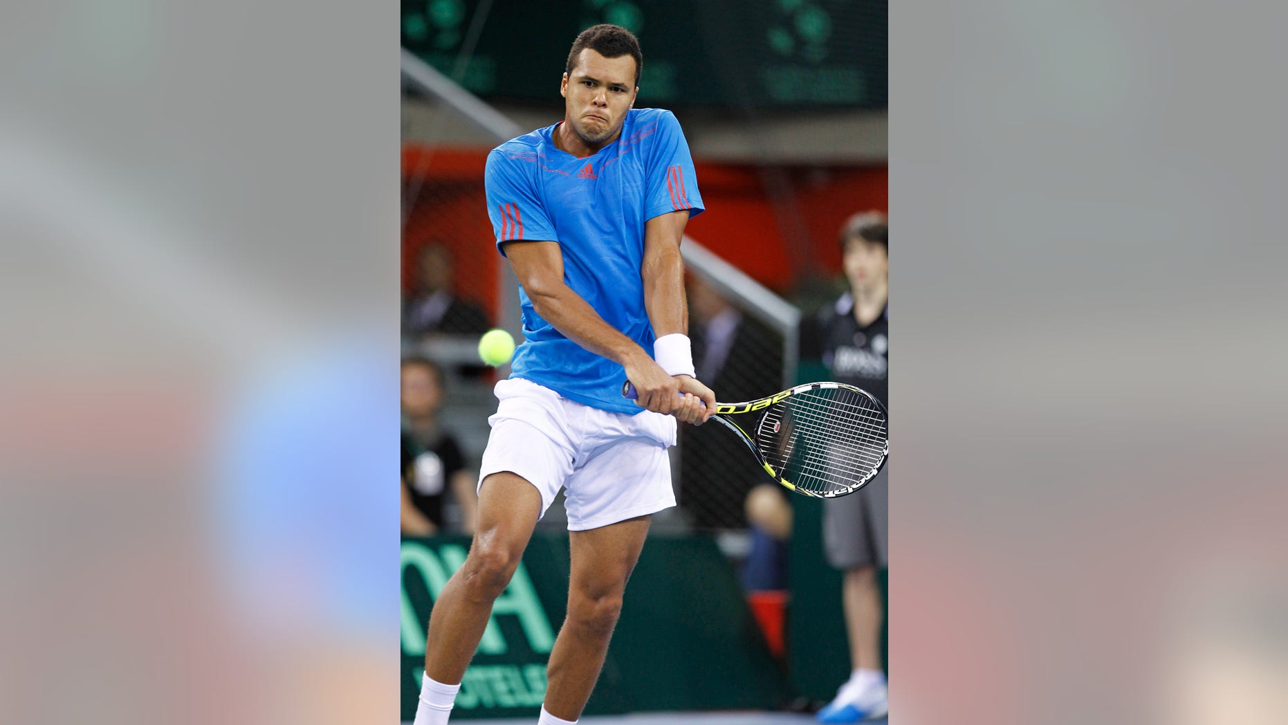 French player Jo Wilfried Tsonga returns the ball to Amir Weintraub of Israel during their match, in the first round of the Davis Cup between Israeli and France, in Rouen, western France, Friday Feb.1, 2013. (AP Photo/Remy de la Mauviniere)