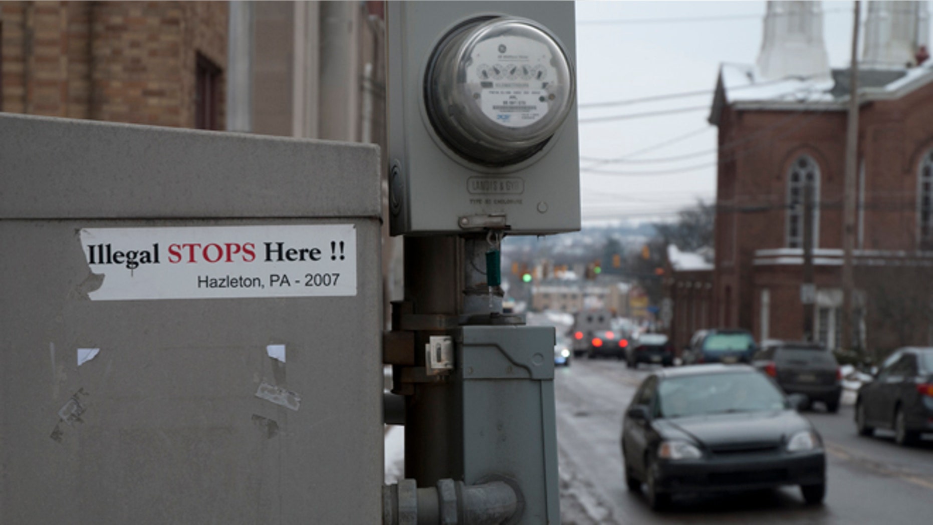 Stickers of the 2006 immigration battle in Hazleton still remain near the town's city hall. (Photo: Andrew O'Reilly)