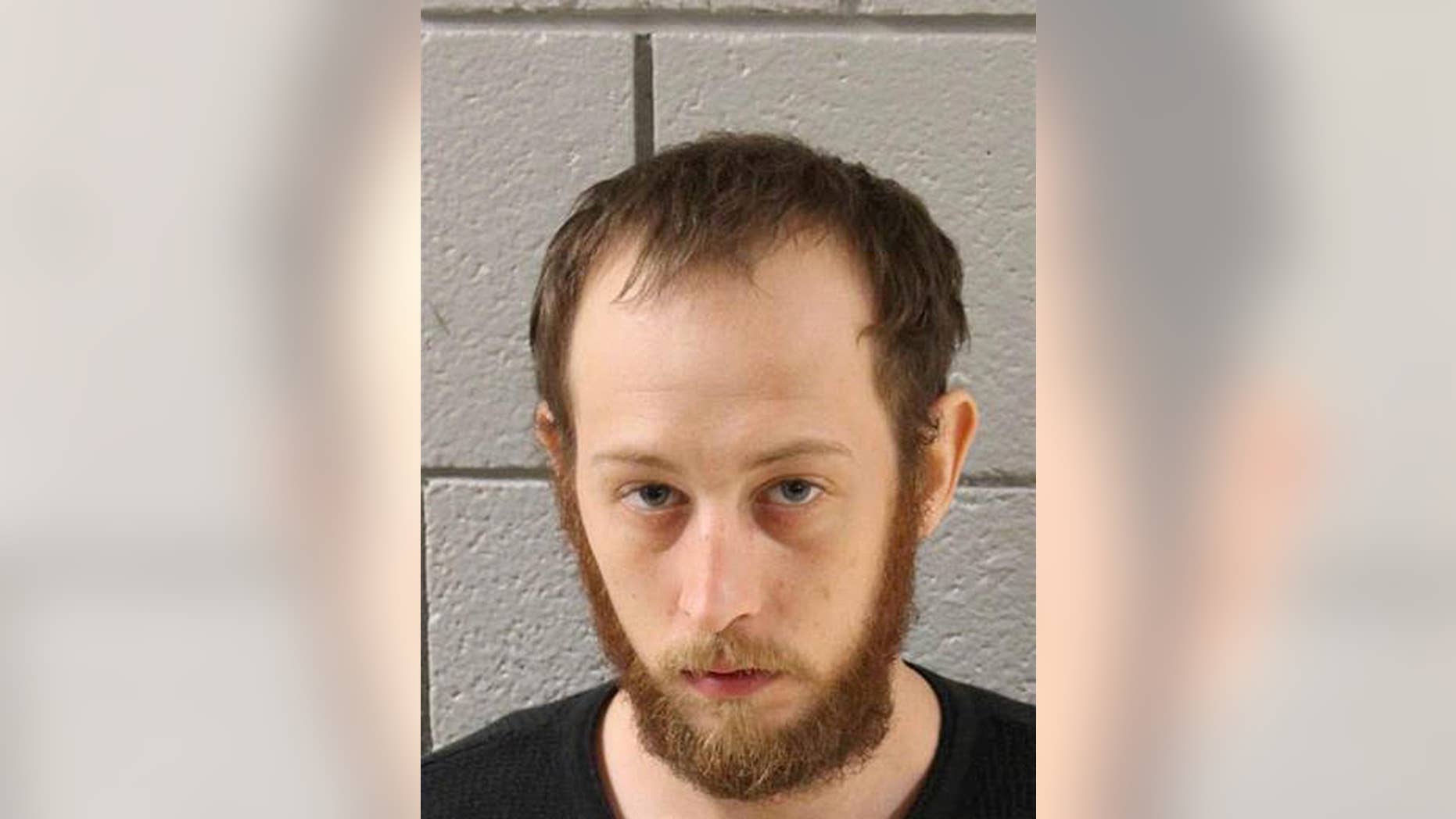 This undated photo provided by the Cumberland County Prison in Carlisle, Pa., shows Joshua Lee Long. Pennsylvania State Police charged Long on Thursday, July 14, 2016, with abuse of a corpse and conspiracy, accusing Long of spraying fluid used to embalm a human brain on marijuana before smoking it. (Cumberland County Prison via AP)