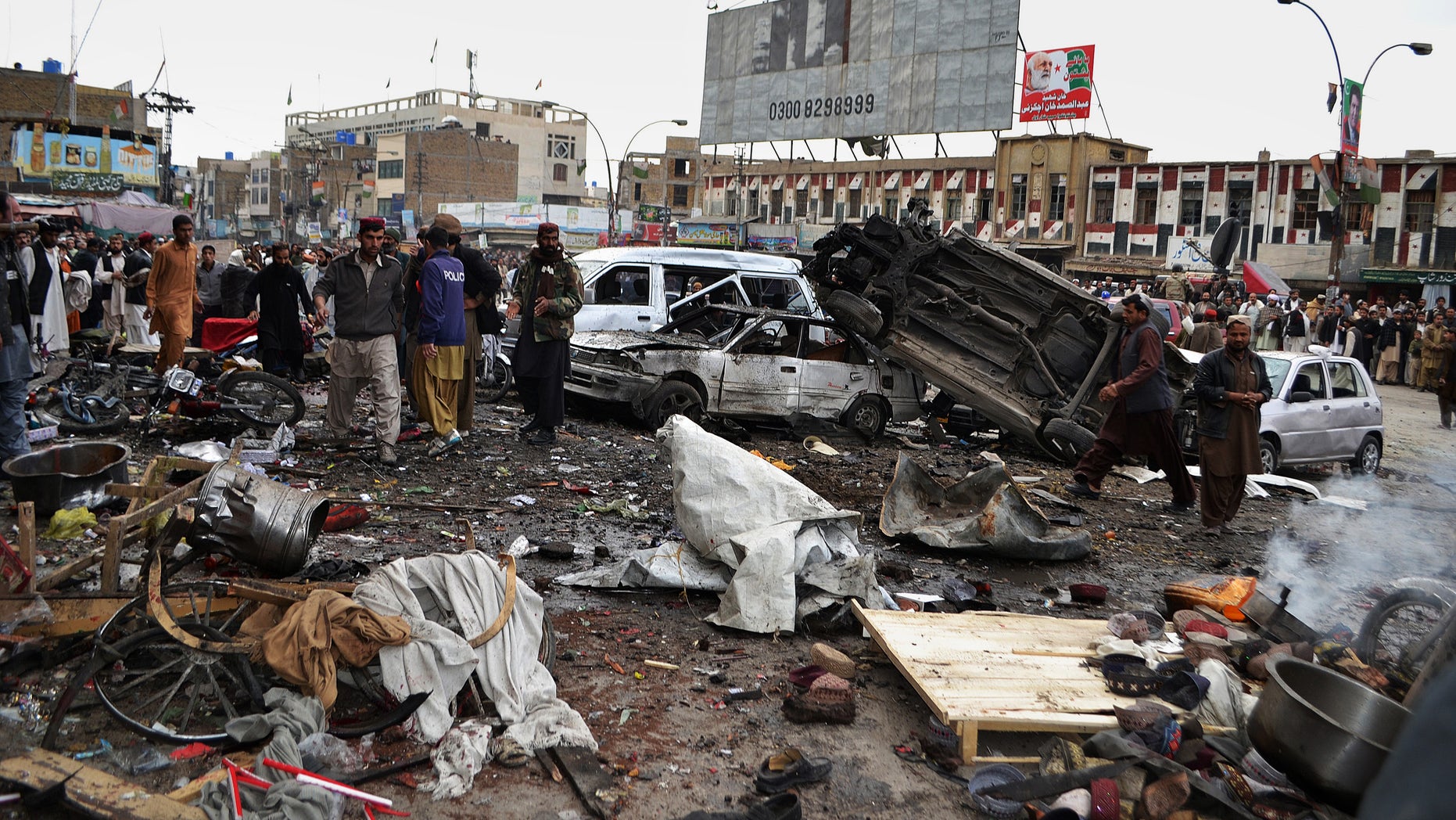Jan. 10, 2013 - Pakistani police officers and local residents gather at the site of a bomb blast that targeted paramilitary soldiers in a commercial area in Quetta, Pakistan.