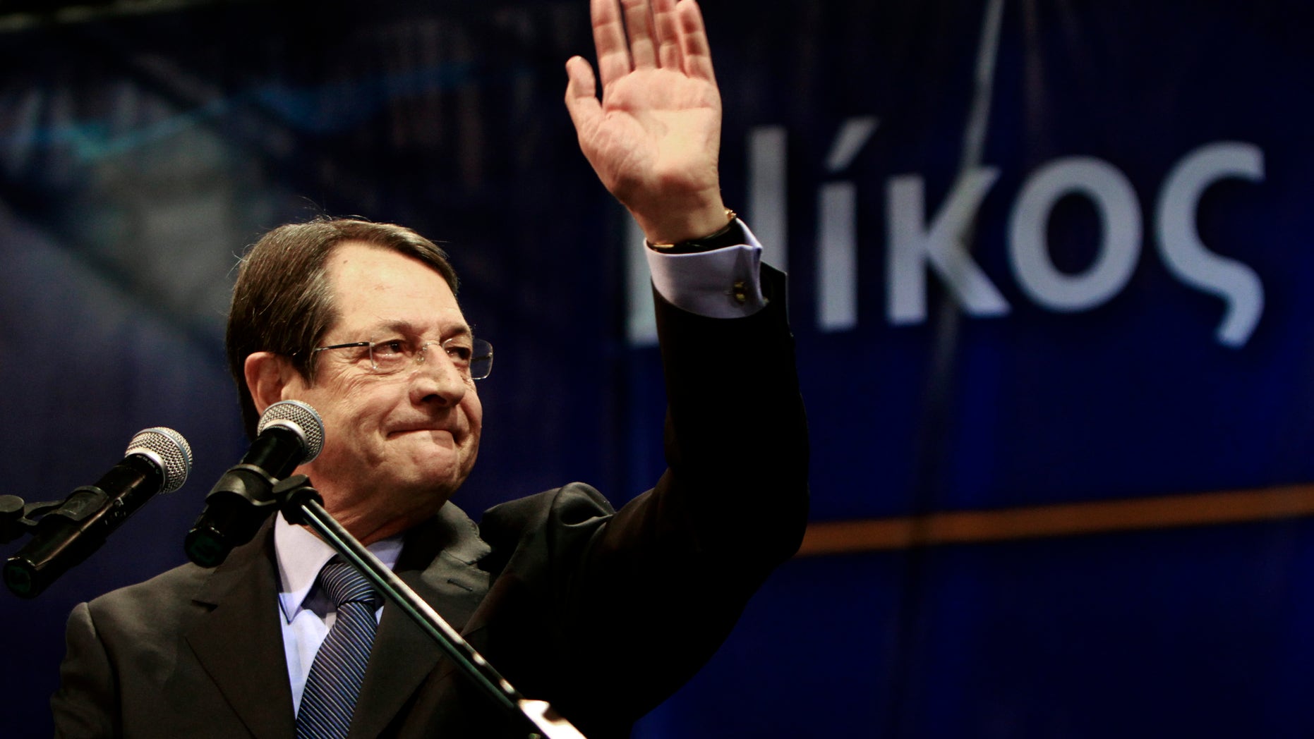 Right-wing presidential candidate Nicos Anastasiades waves to his supporters before his speech during a rally in capital Nicosia, Cyprus, Wednesday, Feb. 13, 2013. Opinion polls a week before Cyprus' presidential election show right-wing presidential candidate Nicos Anastasiades consolidating his substantial lead over his two main rivals. Cyprus presidential elections will take place on Sunday, Feb. 17, 2013. (AP Photo/Petros Karadjias)