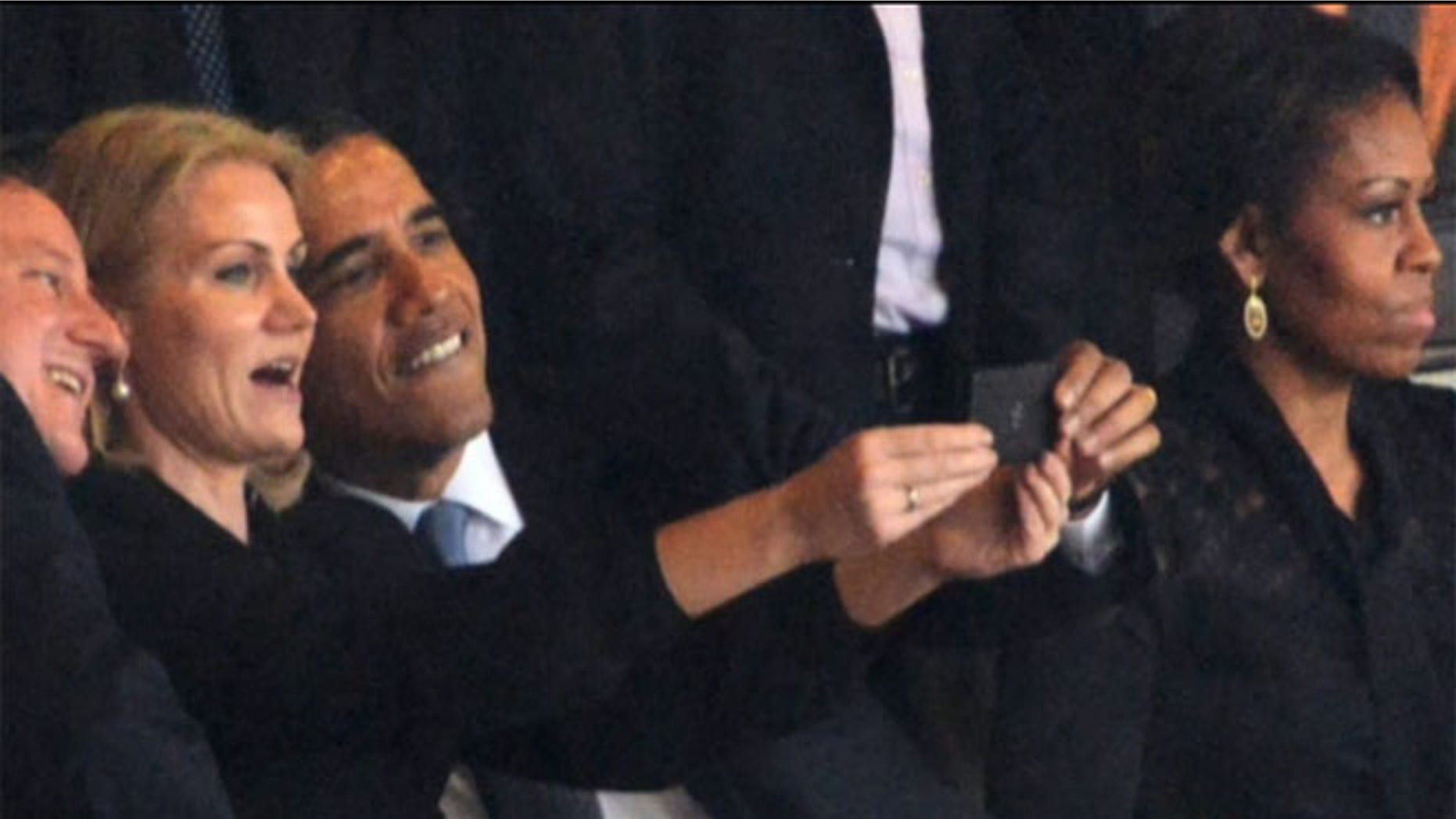 Dec. 10, 2013: President Obama is shown taking a picture alongside Danish Prime Minister Helle Thorning-Schmidt and British Prime Minister David Cameron, in Johannesburg.