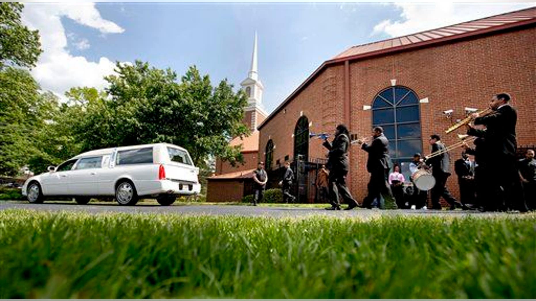 A New Orleans style funeral procession follows the hearse carrying the casket of Chris Smith of the rap duo Kris Kross, after his funeral service, Thursday, May 9, 2013, in Atlanta. The 34-year-old Kelly was found dead May 1 of a suspected drug overdose.
