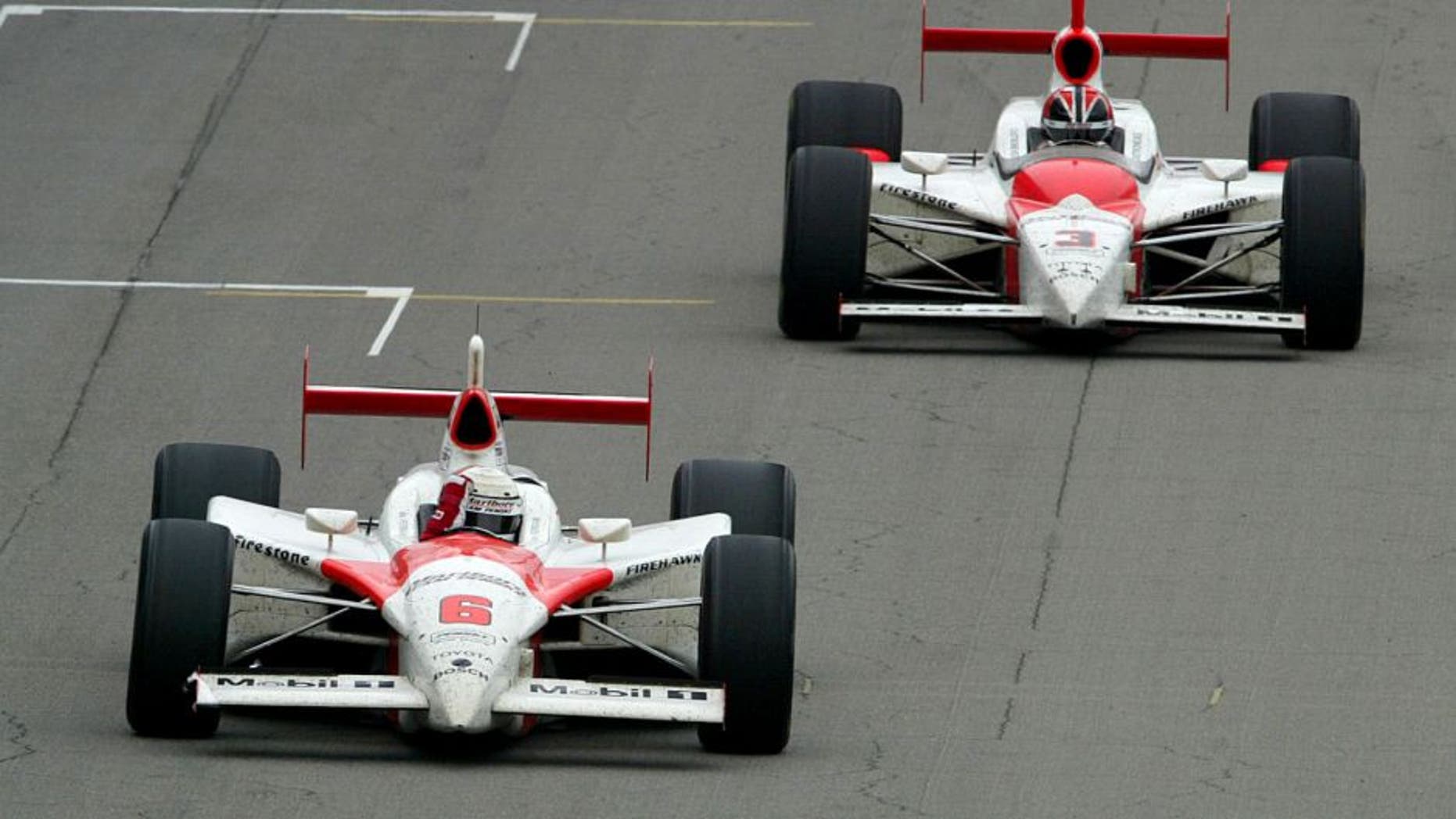INDIANAPOLIS - MAY 25: Gil De Ferran, driver of the #6 Team Penske Toyota G-Force and followed by his teammate Helio Castroneves, celebrates winning of the 87th running of the IRL (Indy Racing League) IndyCar Series Indianapolis 500 on May 25, 2003 at the Indianapolis Motor Speedway in Indianapolis, Indiana.(Photo by Jonathan Ferrey/Getty Images)