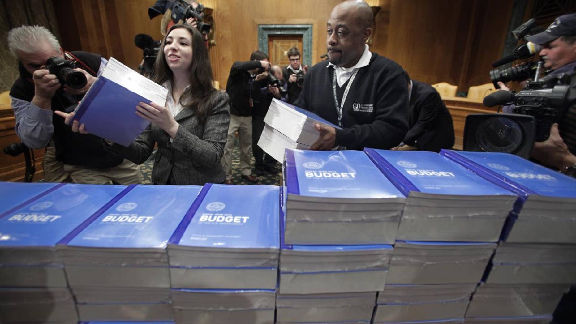 Copies of President Obama's 2012 budget are delivered to the Senate Budget Committee, Monday, Feb. 14, 2011, on Capitol Hill in Washington. (AP Photo/J. Scott Applewhite)