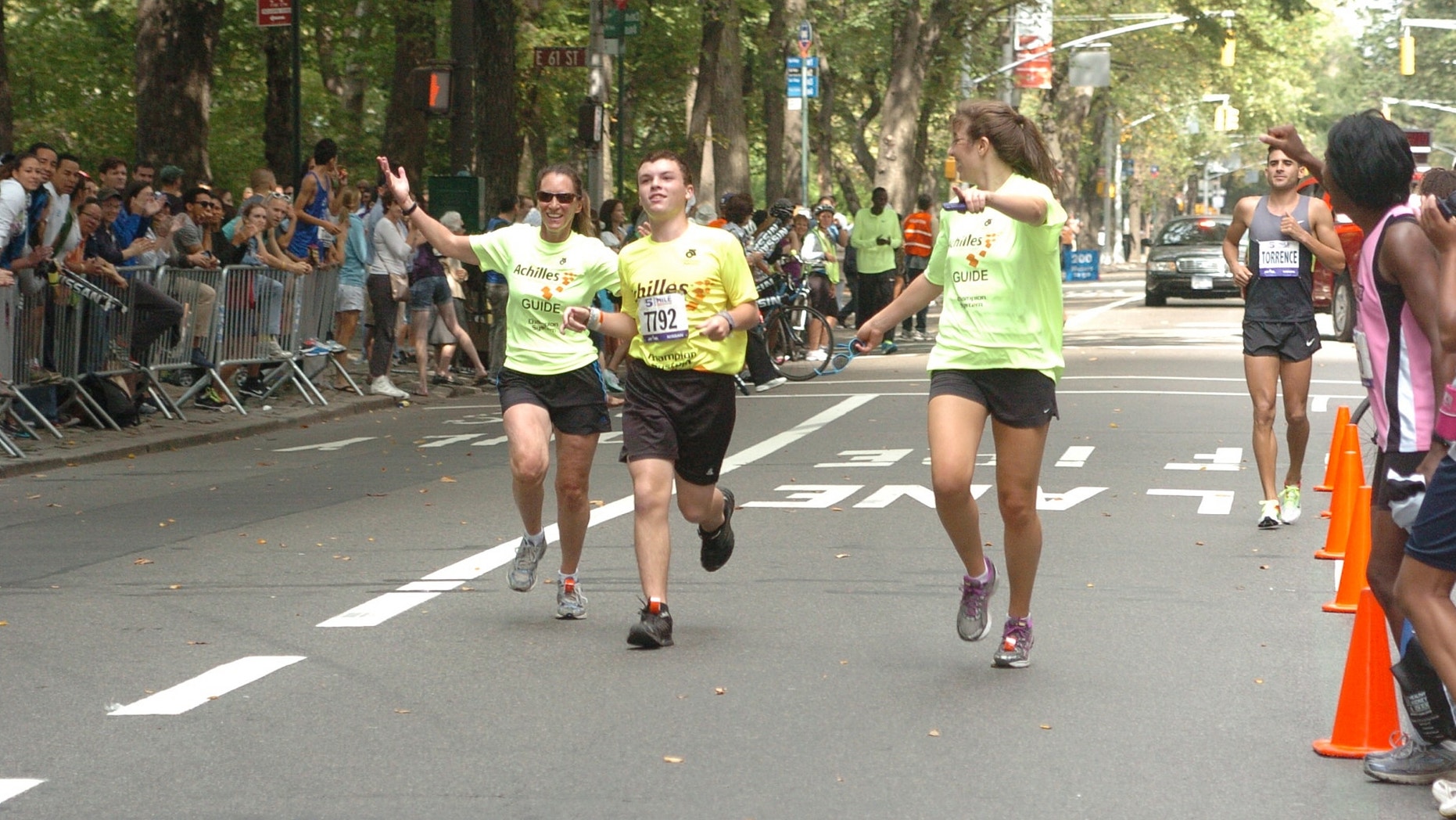 Dusty, his mother Katie, and Paula Sen finishing the 5th Avenue Mile in September 2012 in New York City.