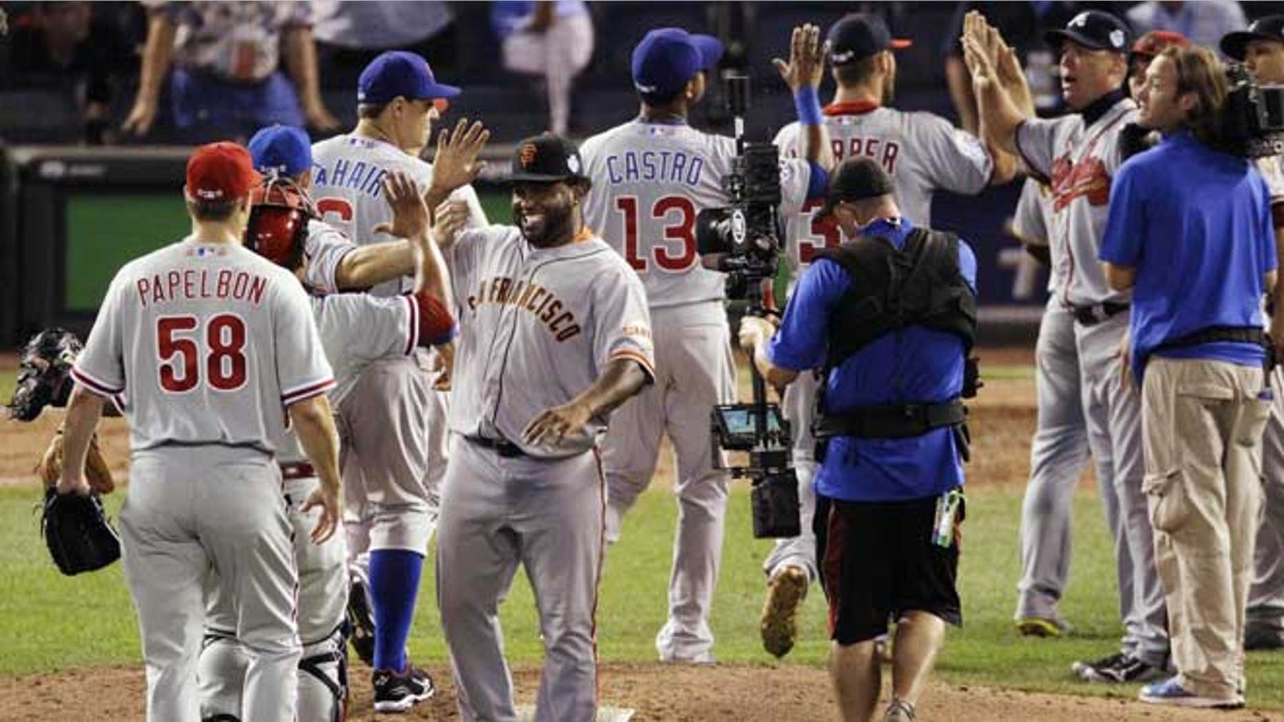 July 10, 2012: National League's Pablo Sandoval, of the San Francisco Giants, right, celebrates with teammates after their 8-0 win over the American League in the MLB All-Star baseball game in Kansas City, Mo.