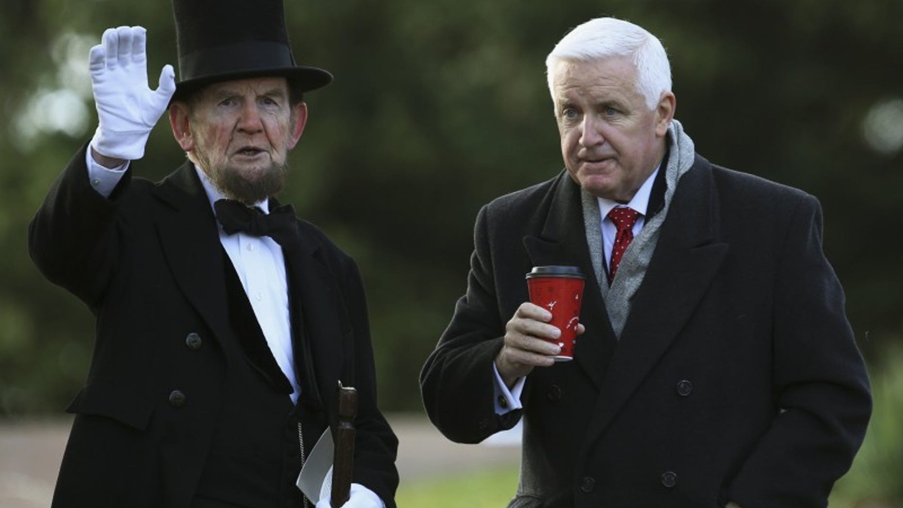James Getty (L), portraying U.S. President Abraham Lincoln, chats with Pennsylvania Republican Governor Tom Corbett (R) before delivering the Gettysburg Address at the Gettysburg National Cemetery in Pennsylvania November 19, 2013. REUTERS/Gary Cameron