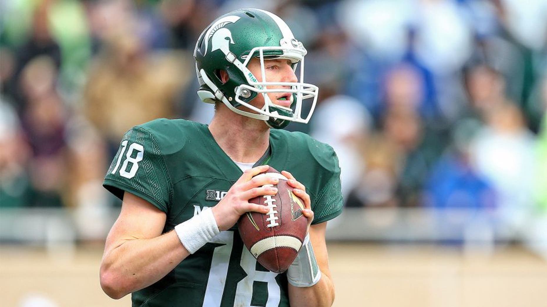 Oct 24, 2015; East Lansing, MI, USA; Michigan State Spartans quarterback Connor Cook (18) attempts to throw the ball against the Indiana Hoosiers during the 1st half of a game at Spartan Stadium. Mandatory Credit: Mike Carter-USA TODAY Sports