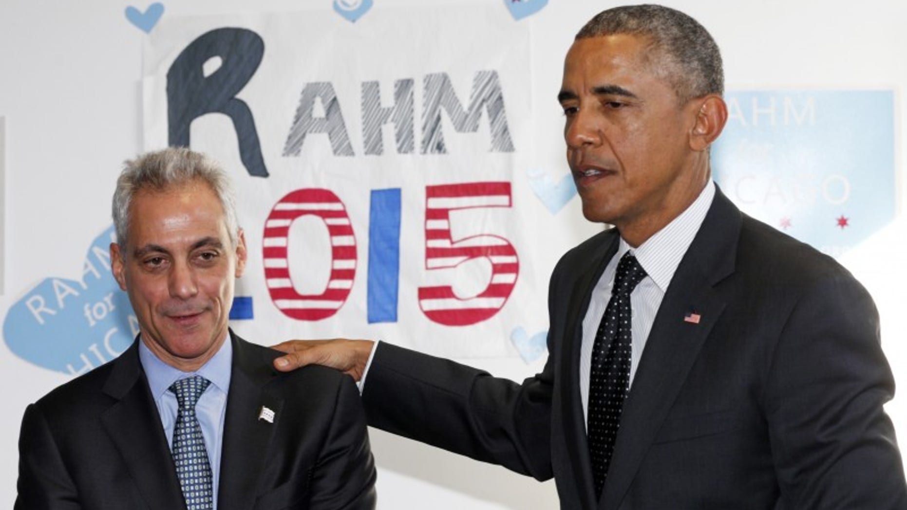 U.S. President Barack Obama puts his hand on Chicago Mayor Rahm Emanuel's shoulder as they visit a campaign office in Chicago February 19, 2015. REUTERS/Kevin Lamarque