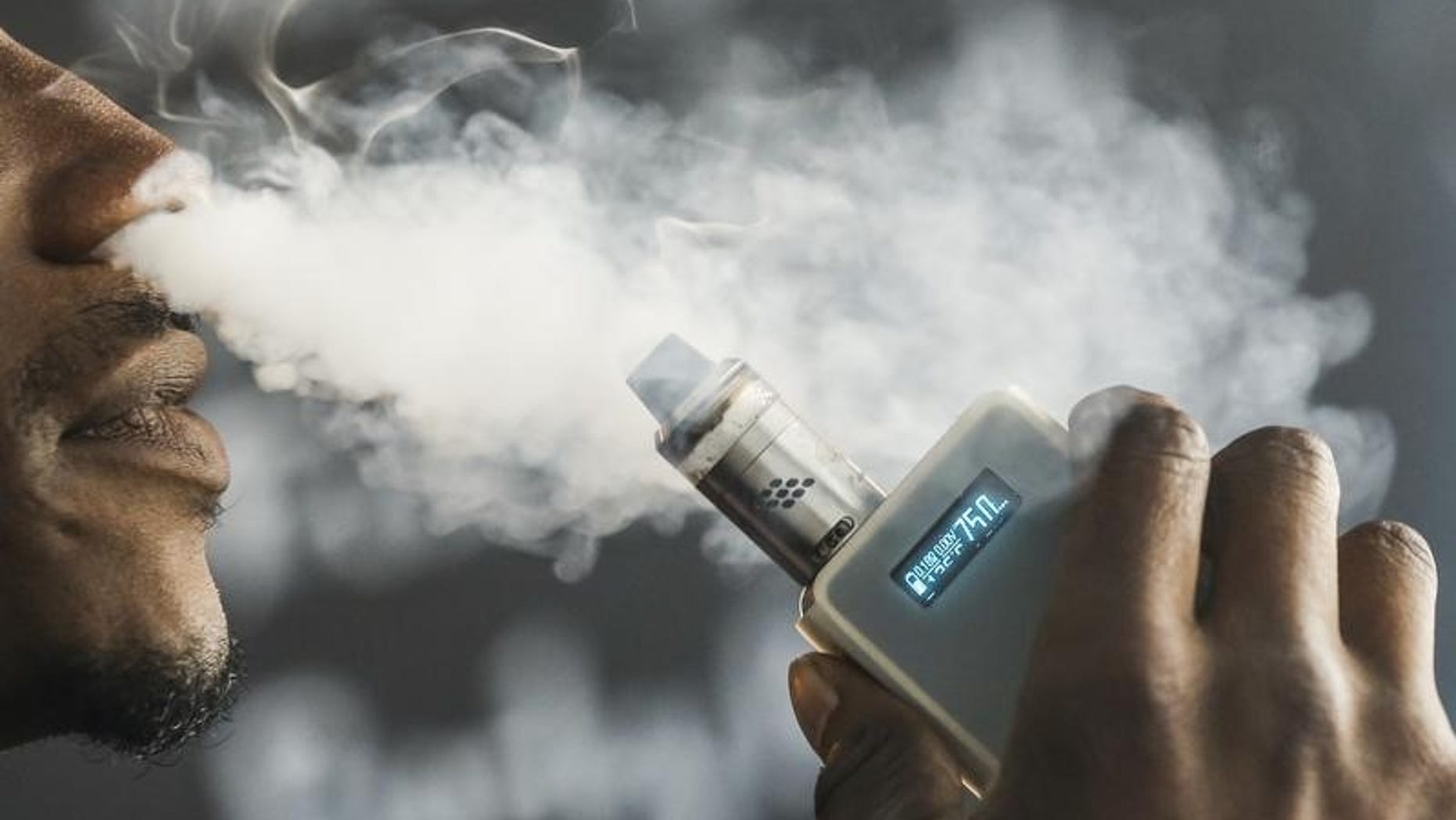 A man smokes an electronic cigarette vaporizer, also known as an e-cigarette, in Toronto, August 7, 2015. REUTERS/Mark Blinch