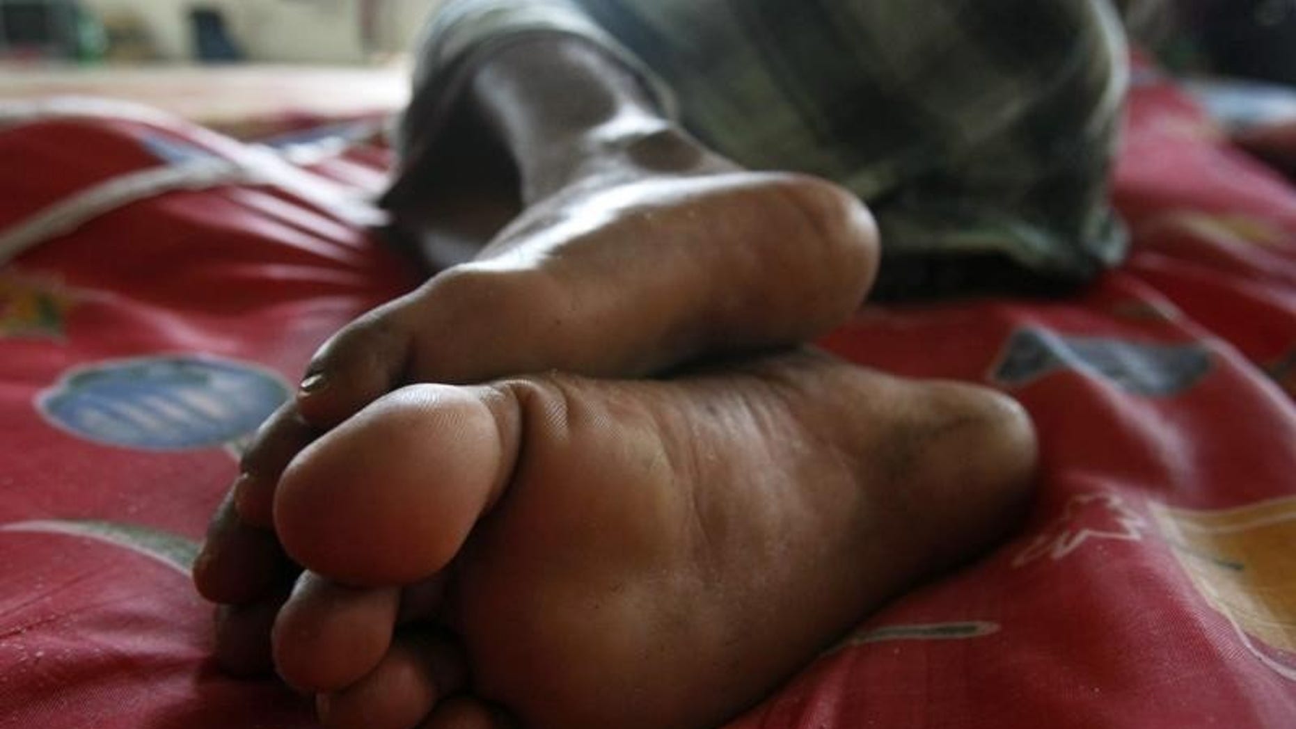 A migrant worker from Bangladesh sleeps on a makeshift bed in a temporary dormitory in Seri Alam near Johor Bahru March 20, 2009. REUTERS/Vivek Prakash