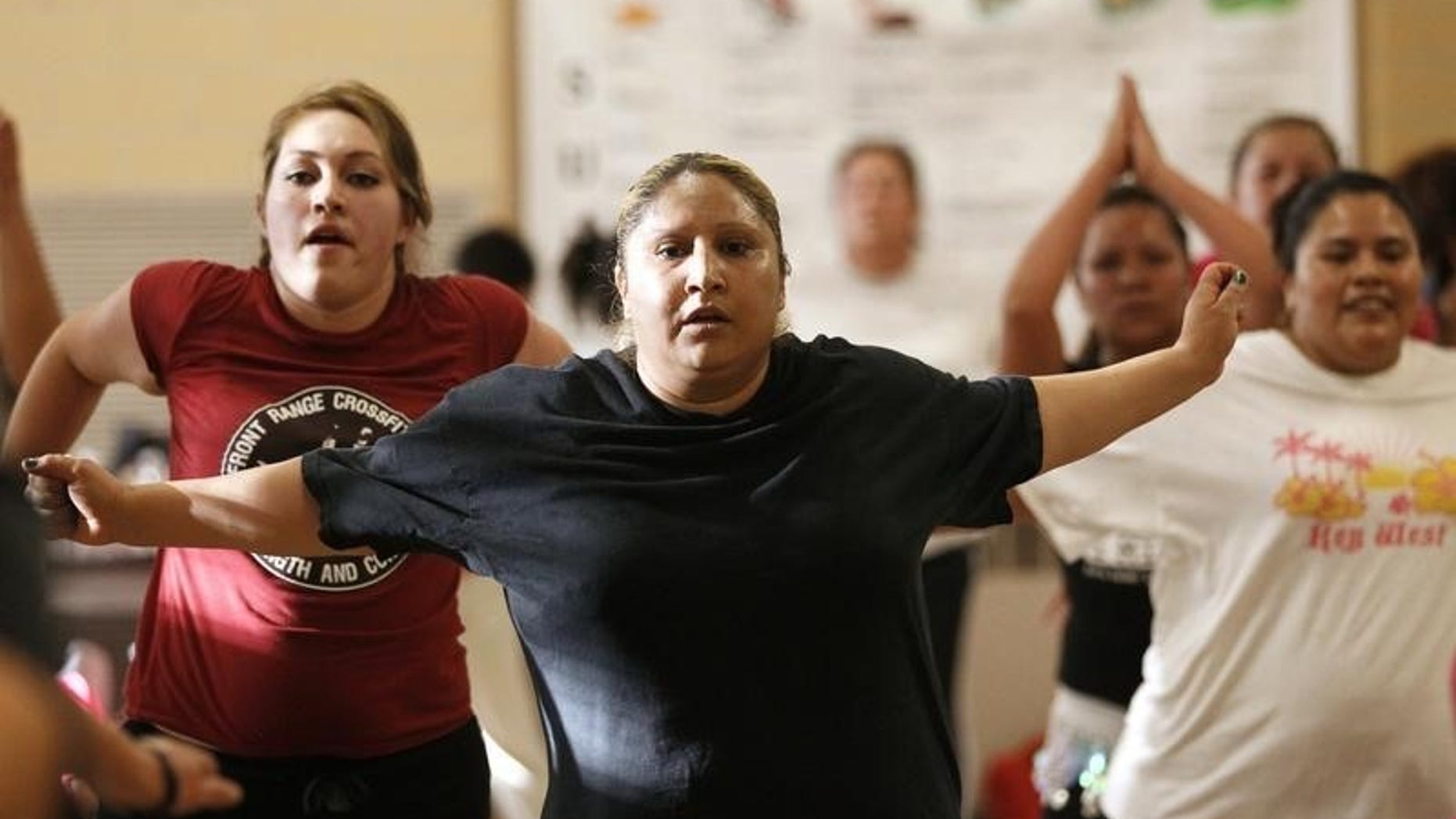 Women participate in a Zumba exercise class in a low-income neighborhood of Denver May 15, 2012. REUTERS/Rick Wilking