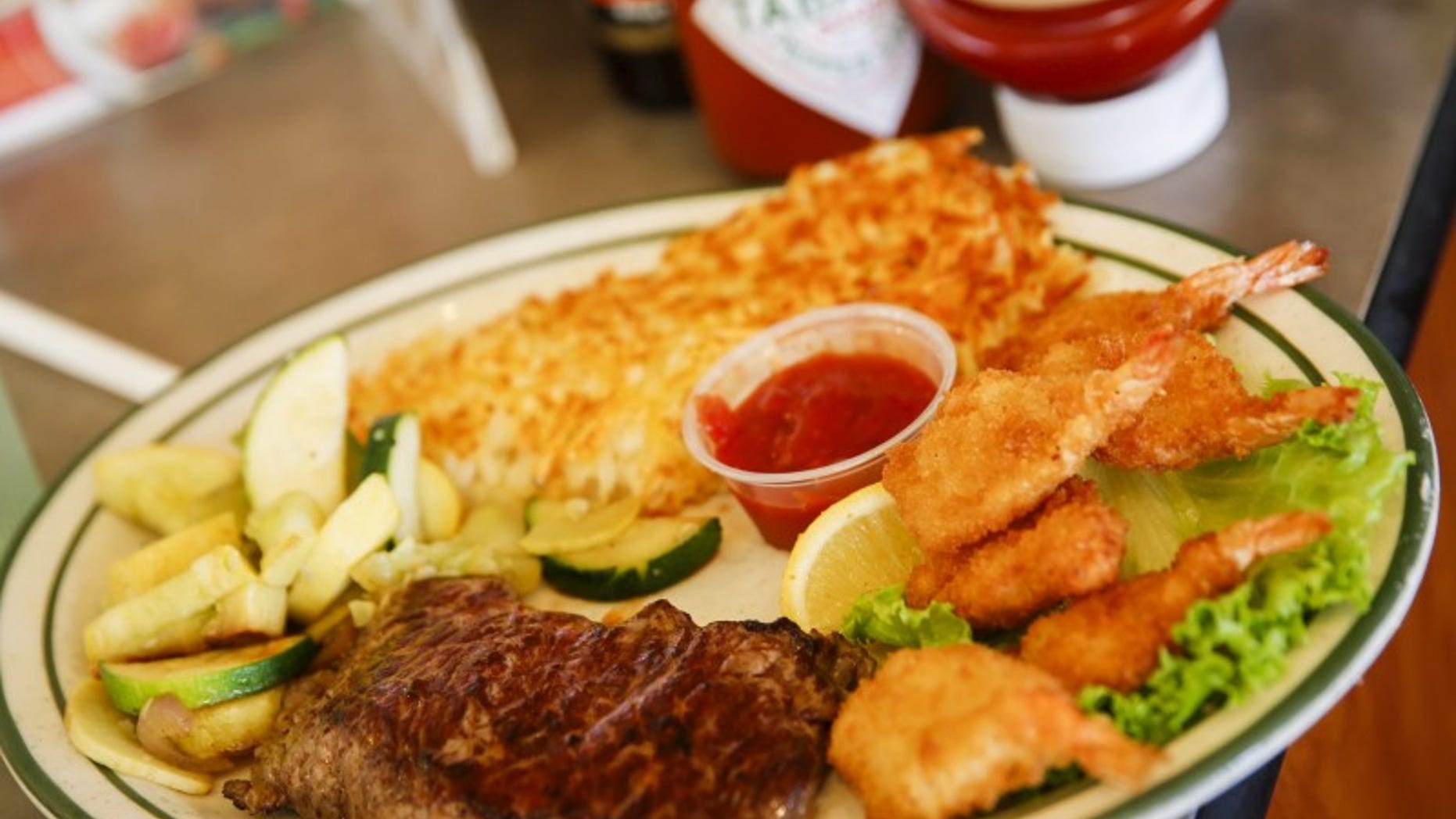 A steak and fried shrimp combo plate is served to a customer at Norms Diner on La Cienega Boulevard in Los Angeles, California May 20, 2015. REUTERS/Patrick T. Fallon